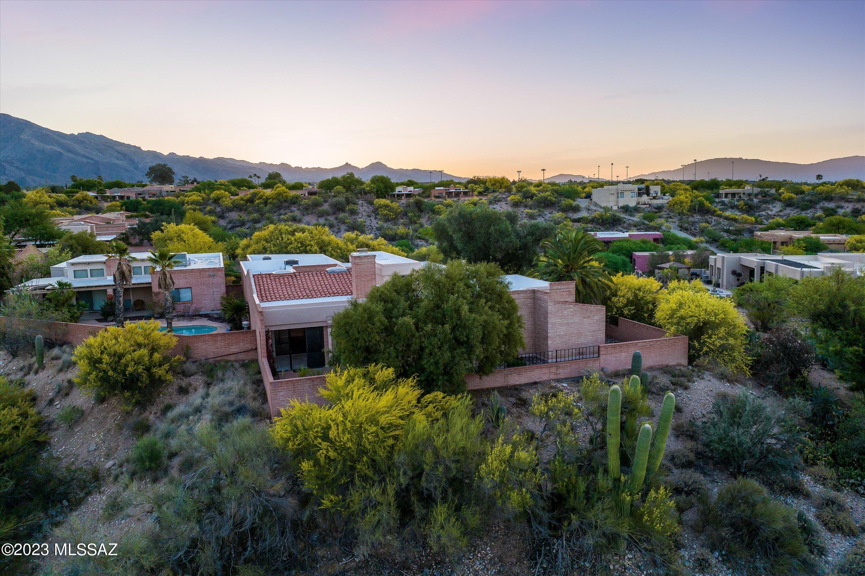 Introducing a truly exceptional property in the prestigious gated community of Pontatoc Canyon Estates. This premier lot is situated on a private cul-de-sac and boasts breathtaking mountain views. Step inside to an updated kitchen with stainless appliances, new porcelain tile floors, and an exhibition chef's kitchen with marble countertops featuring multiple seating areas. You'll love the double pantry, wet bar, and glassed-in Arizona room with travertine floors, perfect for entertaining guests. Multiple outdoor patios, built in BBQ and a featured water fountain all provide for the ease of indoor/outdoor living. This stunning 3 bedroom, 2 bathroom home offers an additional bonus room.