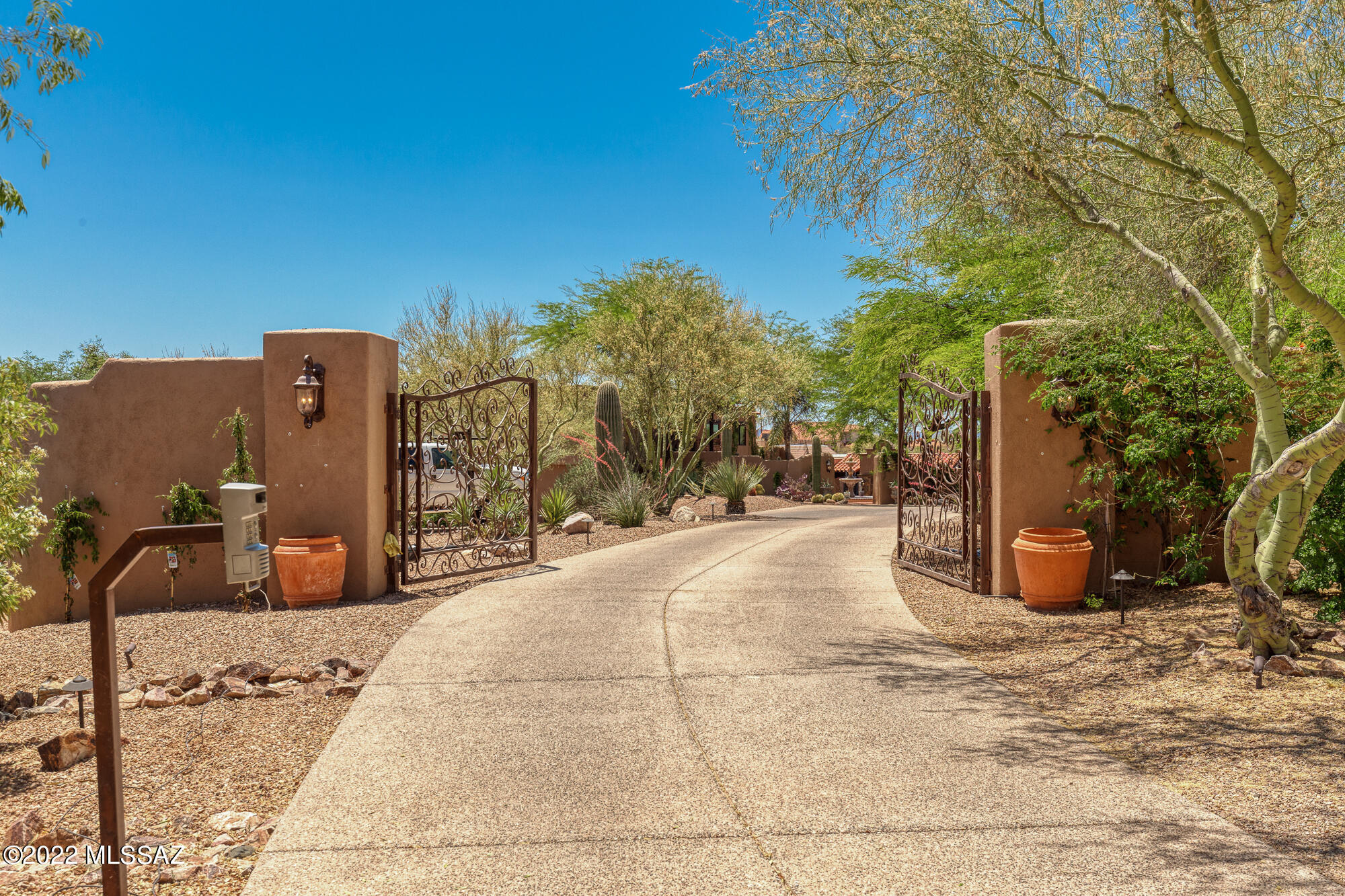 Situated on 3 acres behind a private gated entrance, this beautiful resort-style estate is surrounded by serene desert landscape and city & mountain views. With 5 BR's, 4.5 BA's and a separate office, the home is an expansive 6,048 Sq Ft with no HOA. Entertain friends & family in the spacious yet private backyard which includes pool, waterfalls, ramada, outdoor kitchen, fireplaces and grass. Fully equipped chef's kitchen with Viking SS appliances, including double ovens, wine fridge, and 6 burner gas cooktop. The main level romantic grand owner's suite features a fireplace, enormous walk-in closet, large bathroom with dual vanities, jetted tub and walk-in shower. Upstairs you will find a second ensuite and three additional guest bedrooms with access to the covered deck and roof deck. Adjacent to the 6 car garage sits a flex room with several options as an office, gym, or guest room with direct access to the garage and backyard. The family and entertainment spaces are well appointed and include a TV Room off of the kitchen, Den or Billiard Room, Family Room, Dining Room and large Living Room. Although large and spacious, this estate also offers intimate and comfortable spaces for family and friends.