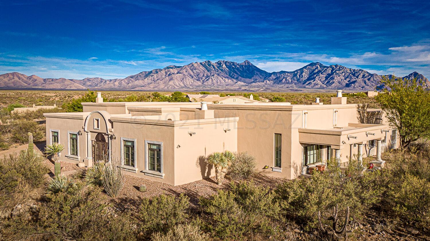 You will be awestruck the moment you arrive at this exquisite Hacienda Estate with 3-bedroom casita. A true gathering place for friends and family, or a quiet get-away with views of the Santa Rita Mtns. The attention to detail by Del Bac Building is apparent in every room! Your guests will be greeted in the beautiful grand entry with access to the courtyard; entertain in the generous family room; or hang out in the comfy kitchen for a cup of java.  Enjoy complete privacy in your master suite w/laundry, craft room and office nearby; escape to the media room to watch all your favorites; wander outdoors to the spacious 2.9-acre lot with middle courtyard to watch the sun rise/set in the beautiful AZ sky. Plenty of room for a pool, toys and extra buildings to house whatever your heart desires! RV Garage w/storage - garage measures 11'6" W x 30' L with 12' door height (buyer should verify as measurements are approximate). Plenty of room for a pool in walled in yard with existing service gate. Or for car nuts extend the garage for those fun historical cars you might enjoy. This warm and inviting home was created with diverse influences from Spain and Mexico incorporated throughout as a result of the original owners gathering their ideas over years of travel. High quality Integra block construction, radiant floor heat, 4 fireplaces, 13.5ft high ceilings, 16inch thick walls, Pella windows & doors and much more to talk about. Be sure to include this home in your list of "must sees" with it's flexibility, it is a top choice. Located for an easy commute to Raytheon, downtown Tucson or Nogales. Please call for a personal viewing.