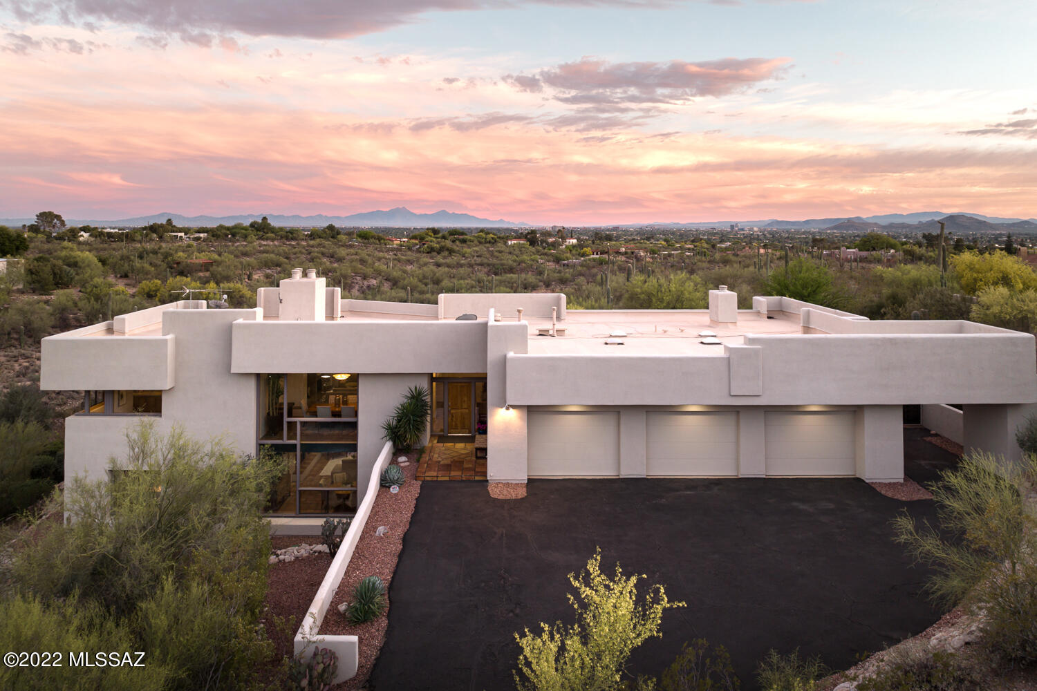 Enjoy ultimate privacy, unobstructed views, and unparalleled stargazing from one of the finest David Tyson designed and built homes to ever come on the market! Situated on over an acre and elevated with expansive city and mountain views that stretch out over the saguaro studded desert landscape. This residence was intricately curated with both modern and southwestern sophistication. At 4,466 square feet, this 4 bedroom, 4 bathroom retreat boasts nearly 2,000 square feet of outdoor patio with beautiful sealed Saltillo tile. The 3-car oversized garage is equipped with plenty of cabinets for storage, along with brand new epoxy flooring and a separate outdoor carport for additional parking. This resort-like home in a non HOA community is the ultimate entertainer's dream and private oasis... The main foyer opens onto a sophisticated living room with Saltillo tile floors that float seamlessly throughout the space, into the kitchen providing a subtle contrast to the custom built-in natural wood cabinetry. The kitchen, designed for a chef, features a Thermador range, Sub Zero refrigerator, Bosch dishwasher, large center-island, and natural stone granite countertops.  The open concept floor plan allows you to flow effortlessly into the family, living, and dining area which showcase the most panoramic and unobstructed views of the Catalina mountains. 

A delicate balance of intimate and public spaces foster a dynamic living environment, with the owner's suite located on the East end of the residence, featuring a combination of luxury treatments and an oversized walk-in closet. With sweeping city views, enjoy a relaxing night with a glass of wine in hand outside on the private veranda off of the master bedroom.  A secondary en-suite bedroom is available on the main level that is generous and bright, situated on the West wing of the residence, perfect for guests or family alike. 

Two supplementary bedrooms and baths are discreetly sequestered on the lower level. The en-suite bedroom offers immediate access to the backyard's covered patio, pool, and spa. The downstairs is complete with a multi-purpose large living room and cozy fireplace (1 of 4 inside) that physically connects the interior to a generously shaded veranda. 

The site was specifically designed to preserve a generous portion of level ground allocated for outdoor living, opening onto multiple large patios, serving as an extension to the interior living rooms. The upper yard located on the primary level, is complete with an outdoor kitchen, with built-in barbecue, cooktop and refrigeration, endless counter space and bar top, and incorporates a dining area with a masonry Chiminea. It's perfectly designed to enjoy the evening sunsets as the city lights come to life. The lower rear yard features an integrated, oversized pool and spa setting the framework for the commanding Catalina mountain and city view corridors, with the capacity to enjoy and entertain being effortless. 

This property is perfectly located in the highly sought after and award winning District 16 schools. You're within minutes to La Encantada shopping center, fine dining, and La Paloma Country Club with world class tennis facilities, fitness, a 27 hole Jack Nicklaus designed golf course managed by Troon, and a resort pool complex.