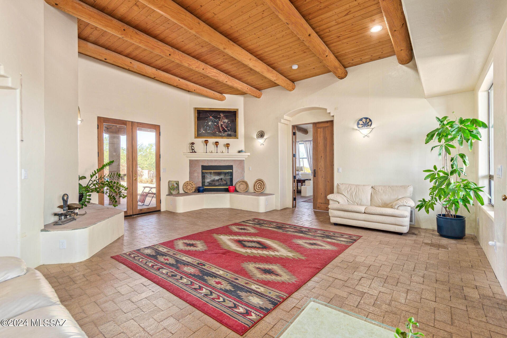 Needs TLC, but priced to sell! Zoned for horse property nestled on 3.37 acres of land in Tucson! Starting w/a 4-car garage, circular driveway, & a courtyard. With an impressive interior, this home shines w/tile flooring, surround sound, recessed lighting, & fireplaces that add warmth to the ambiance. Wood french doors in the bright living room & the desirable great room create a seamless indoor-outdoor transition. Spotless kitchen is fully equipped w/a skylight, SS appliances, abundant cabinetry adorned w/crown moulding, travertine backsplash, a breakfast bar, & solid surface counters. A  peaceful haven awaits in the primary retreat, showcasing exposed ceiling beams, double door entry, sitting area, a gas fireplace, & an ensuite comprised of dual sinks, soaking tub, & dual walk-in closets The tranquil backyard with a covered patio, exterior fireplace, garden fountain, and gazebo is the perfect vantage point to enjoy mountain views & admire dreamy sunsets. Act swiftly!