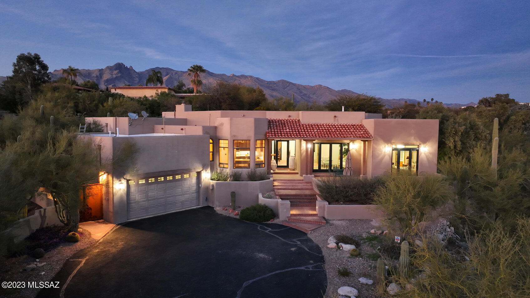 Stunning Custom Classic Southwest Home with a Spanish Colonial Flair sits high on a hill with Spectacular city views. Private Rear Yard with New Pool, Brick Patio's and Charm. Interior features split bedroom plan and sep Laundry, Saltillo tile throughout, Solid 8' Knotty Alder Doors and Trim, Large French Doors to wonderful patio spaces, High Ceiling's, Abundant natural light, Kitchen features white quartz counters all newer stainless appliances and wine fridge. Current owners utilized the 2 guest bedrooms and created a beautiful Suite currently being rented on rental sites with separate private entrance and mini split. Please note that with minor modifications it can be returned to 2 separate rooms. A Special Home!