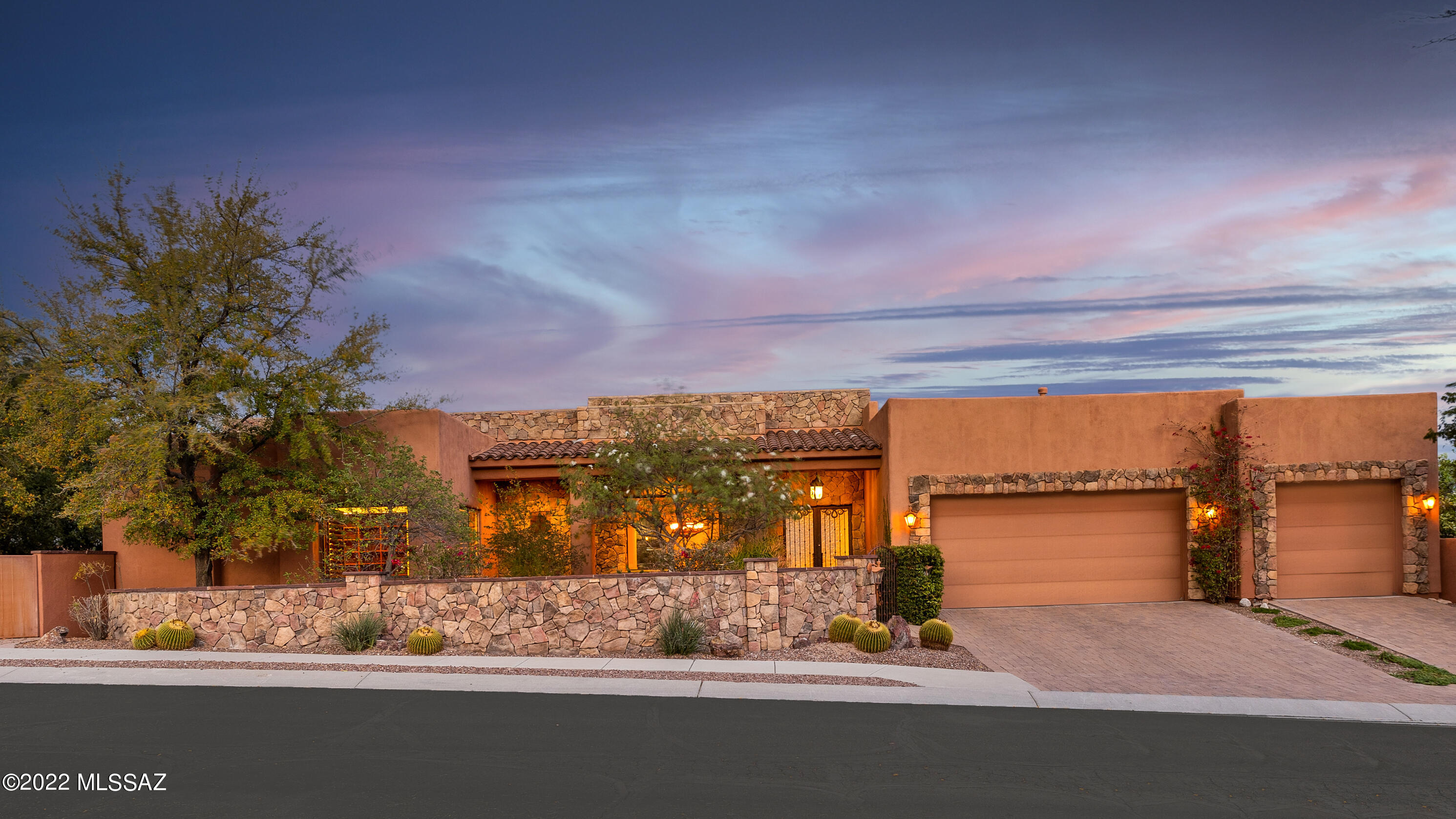 Spectacular views from the walls of glass in this custom home located in beautiful Sabino Mountain. Enjoy the sunrises and mountain views from the large covered patio. Backyard boasts Koi pond, built-in BBQ, built-in fire-pit and hot tub. Chef's kitchen with granite countertops, cherry cabinets and upgraded appliances. All four bathrooms have personal touches with antique vanities and unique sinks. Gas fireplaces in both the living and family room. Huge office with custom bookcases, cabinets and desk. Split floorplan. Slip out of the huge master suite into the hot tub to enjoy the city lights.