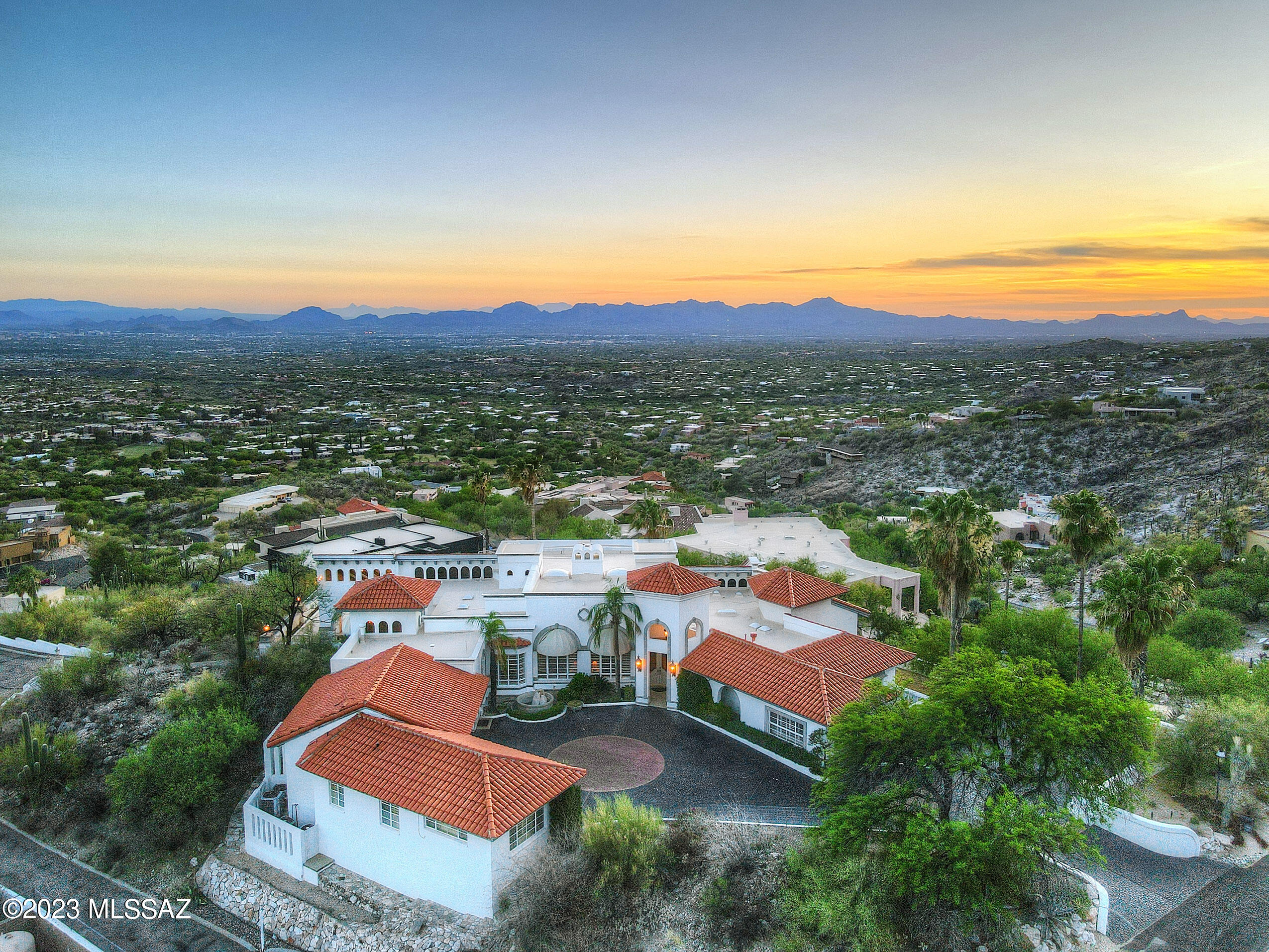 Introducing 5110 E Oakmont, nestled near the top of the prestigious Skyline Country Club neighborhood.  This stunning estate offers a luxurious living experience with breathtaking views. With its prime location, it provides the perfect balance of tranquility and convenience.  Step into a world of elegance as you enter this meticulously maintained and designed residence.  The spacious, over 7,000 square feet layout, boasts an abundance of natural light, creating a warm and inviting atmosphere.  The open concept living area seamlessly flows through to the gourmet kitchen making it ideal for entertaining large amounts of guests or enjoying quality time with loved ones.  Indulge in ultimate relaxation in the master suite featuring a private oasis complete with spa-like en-suite bathroom area. The additional bedrooms and bathrooms, including attached guest house, offers ample space for family members or guests, ensuring everyone feels right at home.  Outside the low maintenance and meticulously maintained grounds provide a private and serene escape from the hustle and bustle of everyday life.  Whether you are lounging by the pool, hosting a barbeque on one of the expansive patios, or simply enjoying the stunning views of the mountain and city lights, the space is perfect for creating lasting memories.  Located in the Skyline Country Club, residents have world class amenities nearby, including a championship golf course, tennis courts, and a clubhouse with fine dining options.  Additionally, the proximity to premier shopping, as well as dining and entertainment, ensures that everything you need is just moments away.  In addition to this incredible home, this list price also includes the lot to the east at roughly 1.2 acres that this home in the past has used as additional space for valet parking for large entertaining events and could be used for such still or perhaps additional guest house space or large car garage/museum, art studio, or any other additional space envisioned and dreamed of by its next owner.  Address of lot is 5120 E Oakmont and is listed separately as well but would be included at this price.
