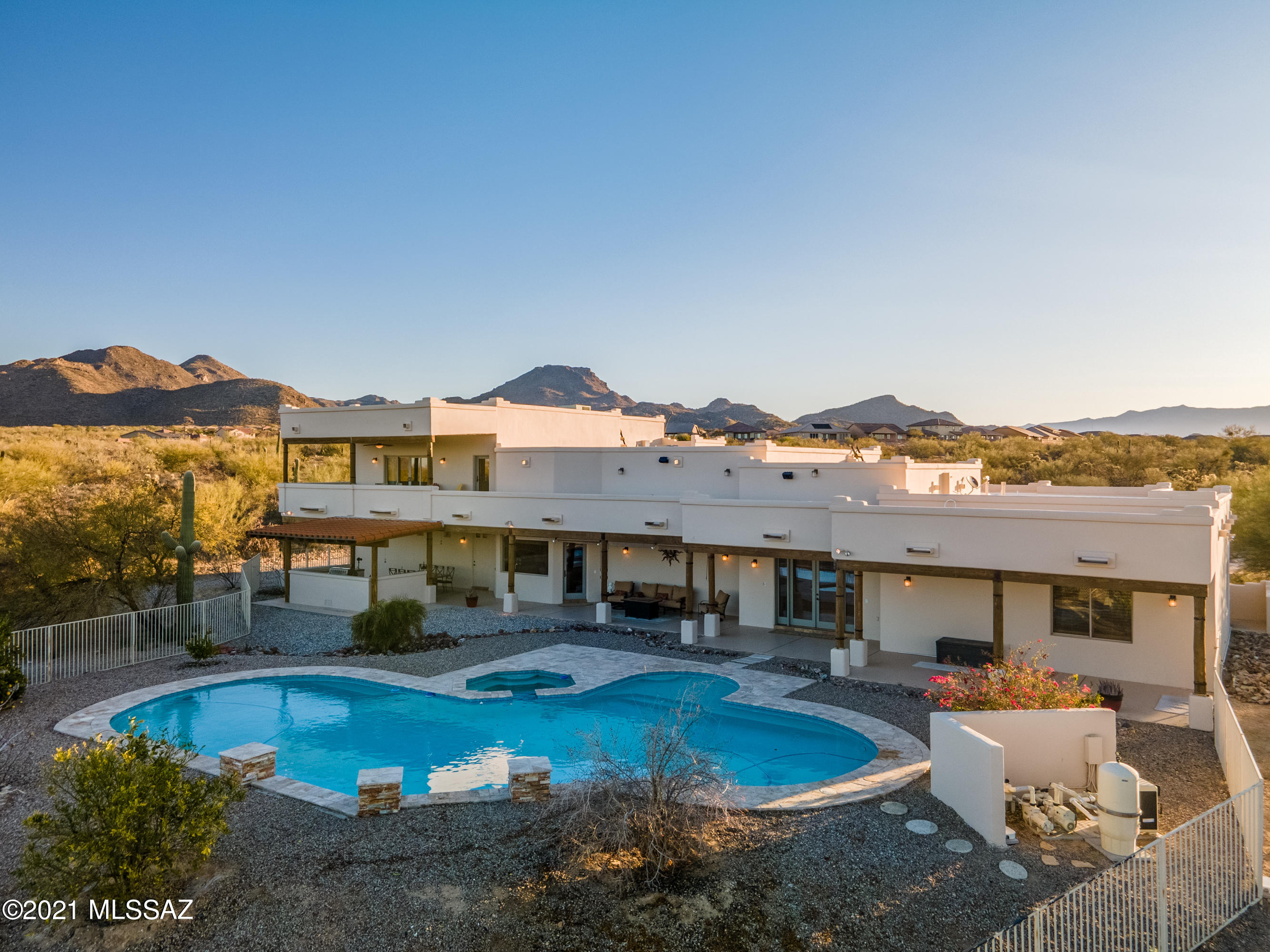 This gorgeous estate is situated on 5 acres in Dove Mountain and boasts amazing 360 degree views! Chef's kitchen with large island, dual ovens, and gas range that opens to great room.
Exposed beams throughout the home give an elegant southwest flare. Resort style outdoor living with an inviting heated pool and spa and covered built-in BBQ/outdoor kitchen area. Private
master suite is on its own wing with a jetted tub, walk-in dual head shower, steam shower, dual vanity, large closets and private balcony. Large guest rooms with ensuite baths. An oversized 4 car garage has plenty of room for cars
and toys. Peaceful and quiet setting yet close to many amenities. Horses allowed if desired. Ritz-Carlton Resort, The Gallery Golf Club, parks, Tortolita Preserve, new school, shopping