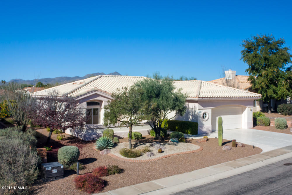 Sun City Oro Valley- Expanded 1,818sf 2BR/2BA Sunrise model on premium lot backing to Open Space w/no homes behind.  Kitchen has Corian counters, abundant cabinets & desk area.  Family room off kitchen has gas fireplace w/raise hearth. Formal Living/Dining area. Master suite has jetted tub, separate shower, double sinks & walk-in closet. Laundry room has utility sink, closet & cabinets. Low care backyard has covered patio & extended brick tier patio areas. Epoxy coated 2½ car garage & driveway. All appliances stay. Silhouette blinds, tile in kitchen, baths & family room.  Security screen doors front & back. Sun City features 18 hole golf course, tennis courts, Rec center, craft complex, library, pool, fitness center, genealogy, learning Center & more.