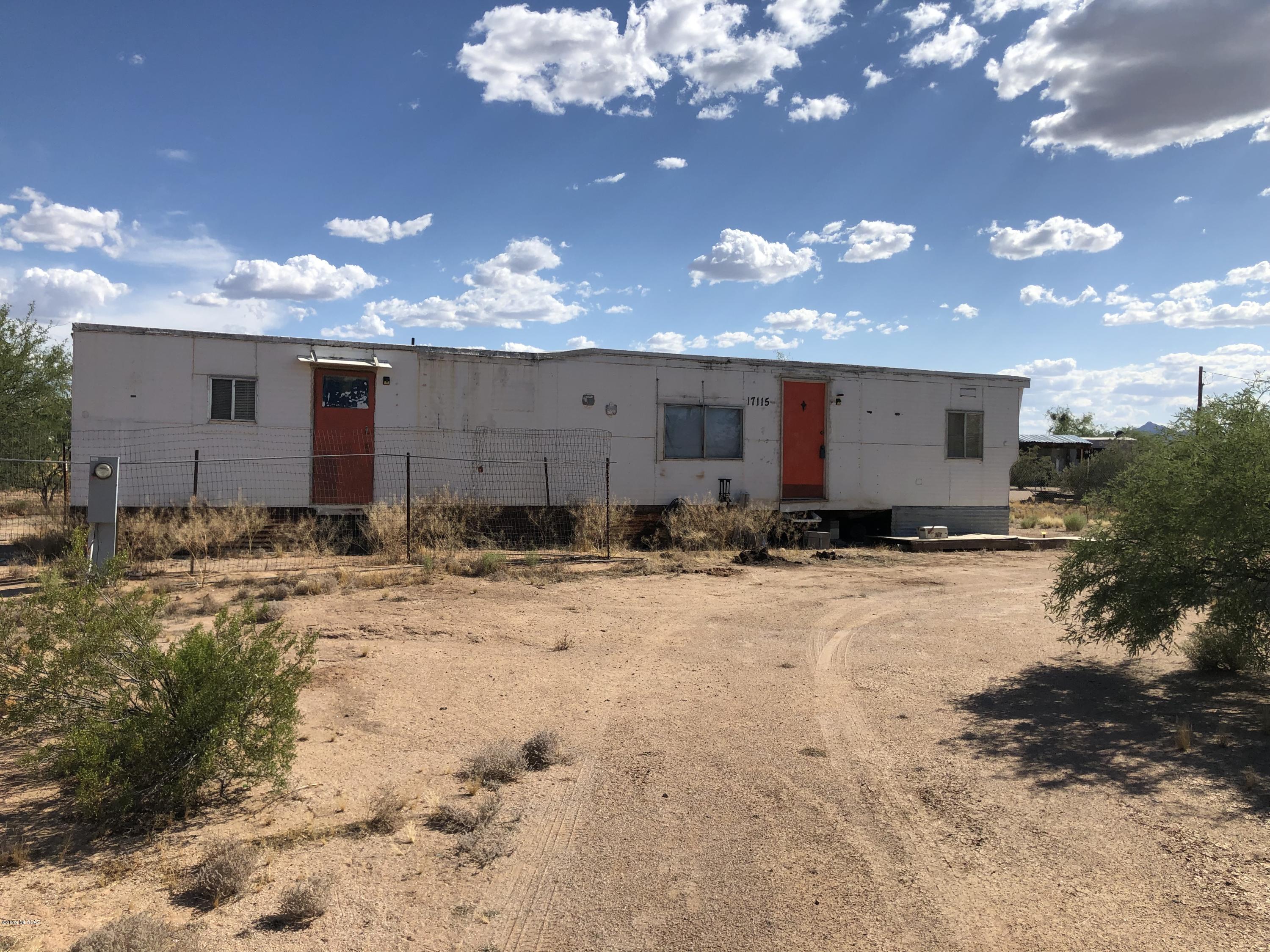 Livable mobile home on a 1.2 acre lot that's fully fenced. It's only 700 feet of dirt road - the rest is paved. All utilities - city water, electric, gas and septic - are included. Fully functional! The location has easy access to I-10, but still allows for country living. Seller financing is available - easy qualify with $5,900 down and negotiable terms. Mobile home as is. Owner has an ADOT title. No CLUE, No SPDS