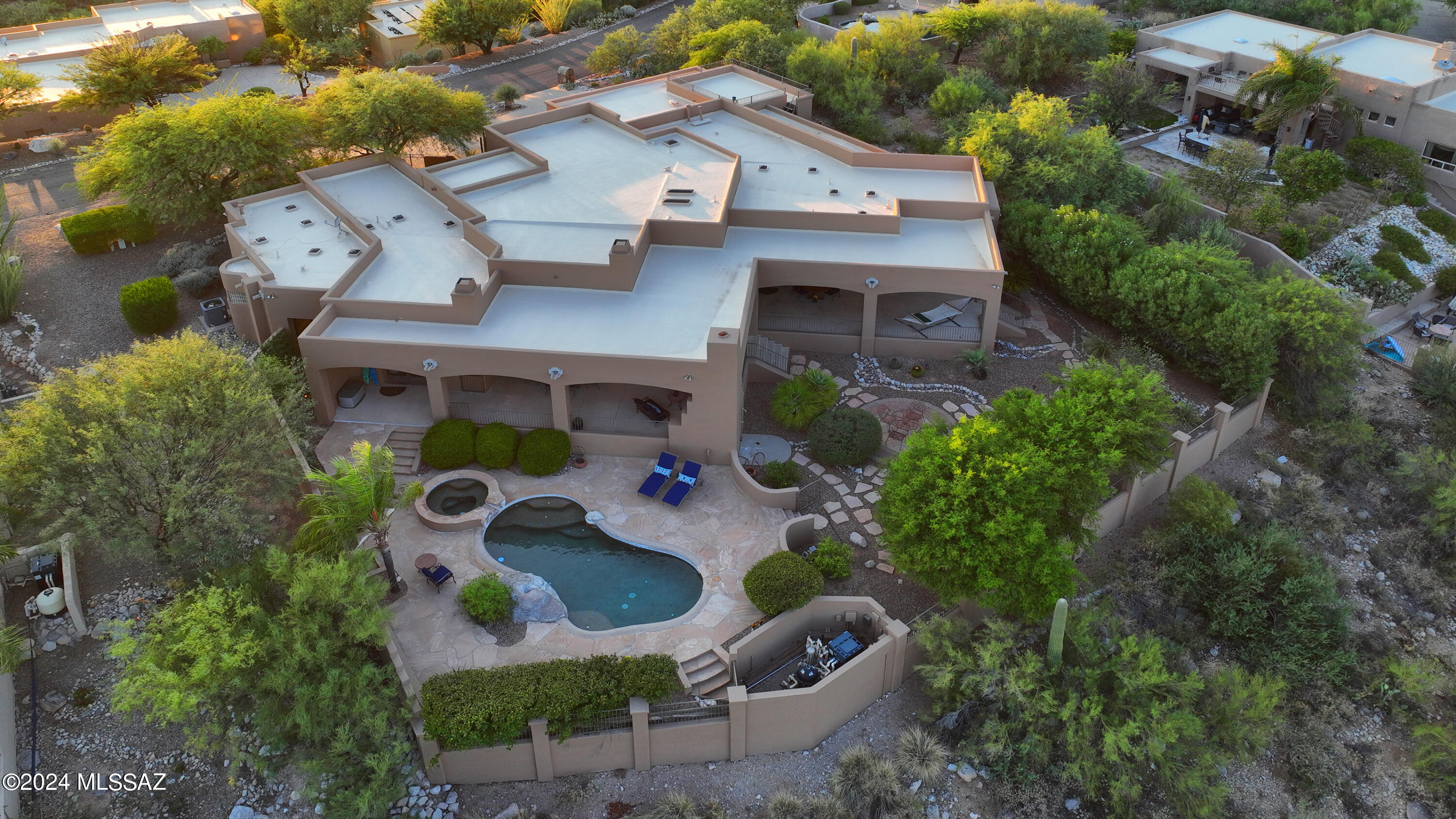 Magnificent residence in prestigious Alta Vista, high in the Catalina Foothills.Designed by Ron Robinette & built by Chris Kemmerly, featuring an open floorplan. Dream primary suite with fireplace, sitting area, stone wall, 2 walk-in closets & spa bathroom. Updated chefs kitchen. Office features built-ins. Amazing oversized covered porch with built in BBQ & fireplace overlooks the sparkling pool & spa and an up close view of Catalina mountains. Huge 3 car garage with workshop area & storage room. Guest wing includes 2 large bedrooms with unique 2 sided Jack n Jill bath, + additional Media Room/ Den that could easily be converted to a 5th bedroom, & another full bath. Laundry/ craft room is a bonus with access to the stairs up to the 360 views from the roof deck. Perfect for entertaining!