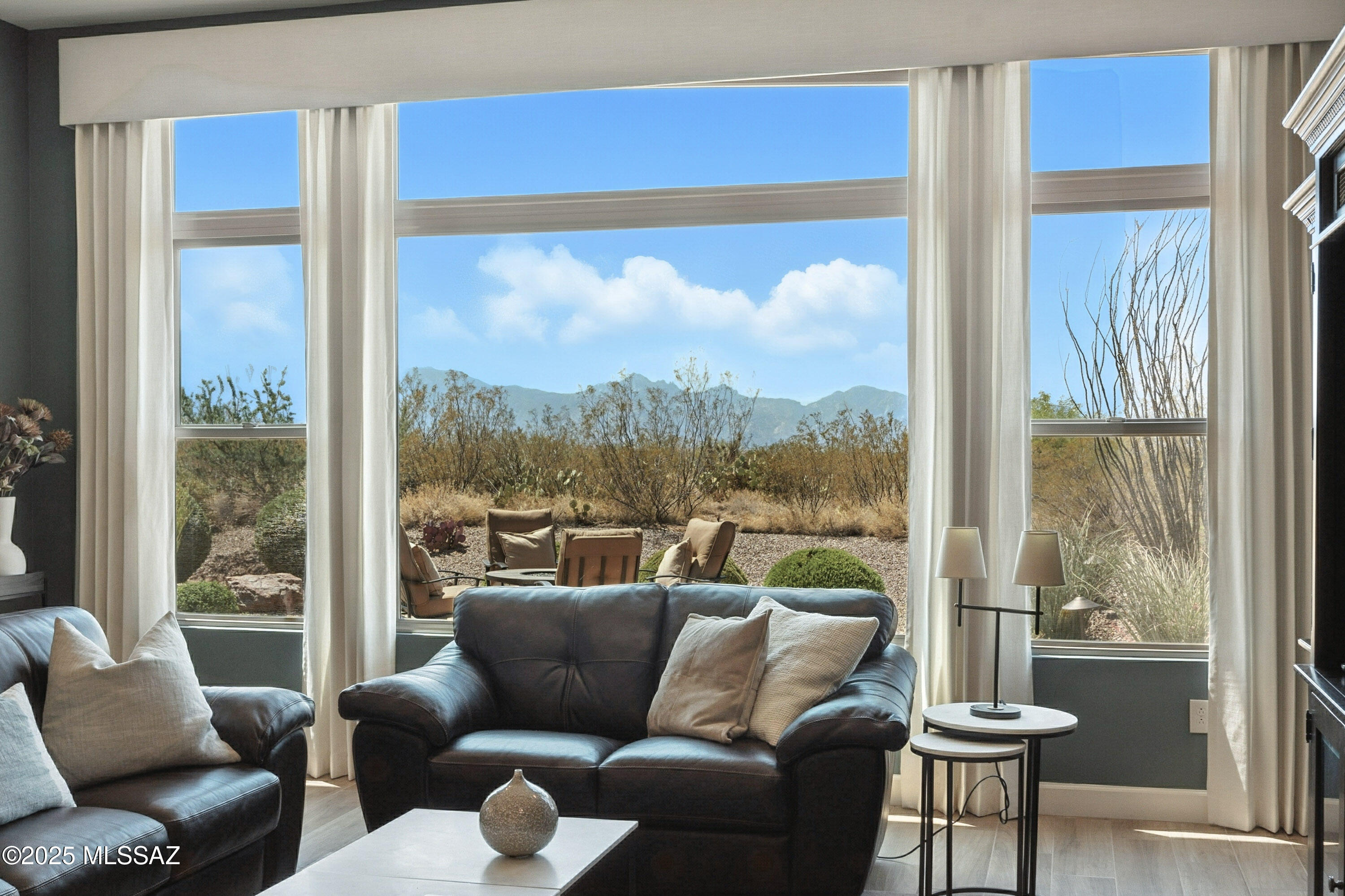 This rare 2016 Fresco offers refined desert living with AMAZING MOUNTAIN VIEWS and no homes behind. Featuring 2 bedrooms, den, 2.5 bathrooms. This home showcases exceptional design and thoughtful upgrades throughout. A charming courtyard and custom front door set the tone, leading into an open-concept great room with a wall of windows and seamless access to the covered patio. The gourmet kitchen boasts SS appliances, quartz countertops, gas cooktop, and a blend of white & alder cabinetry with pull-outs, while the adjacent dining area includes a stylish wet bar. The owner's suite offers a luxurious bath with walk-in shower & closet. A private guest suite, den with French doors. Wood-look tile flows throughout. All in the community of SaddleBrooke Ranch, a premier active adult community. The expanded 2.5-car garage features a water softener, and the laundry room includes a sink and ample storage. Outdoors, enjoy an extended paver patio, relaxing firepit, electric rolling shades, and impeccable landscaping, all framed by captivating mountain views.