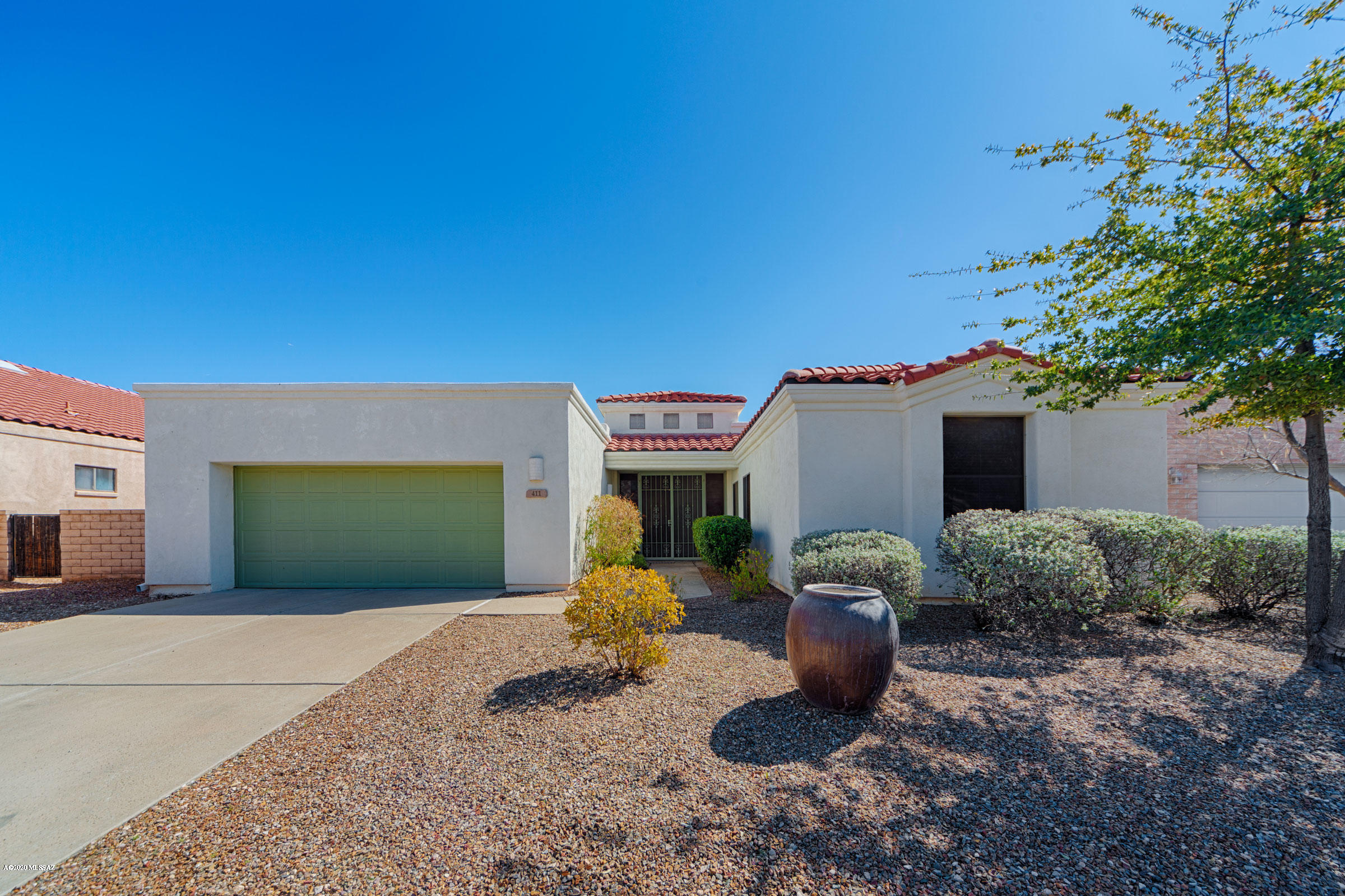 Terrific central Tucson location! Very private gated community of semi-custom homes. Covered entry with steel security doors.   Three bedroom two full bath split bedroom floor plan. Open concept kitchen with all appliances remaining. Plenty of counter space, breakfast bar and a closet panty. Large great room features corner gas fireplace and slider to covered patio. Outside is a well landscaped backyard and extended flagstone patios. Neutral colors throughout. Carpets and home have been commercially cleaned. Ready for you to enjoy!