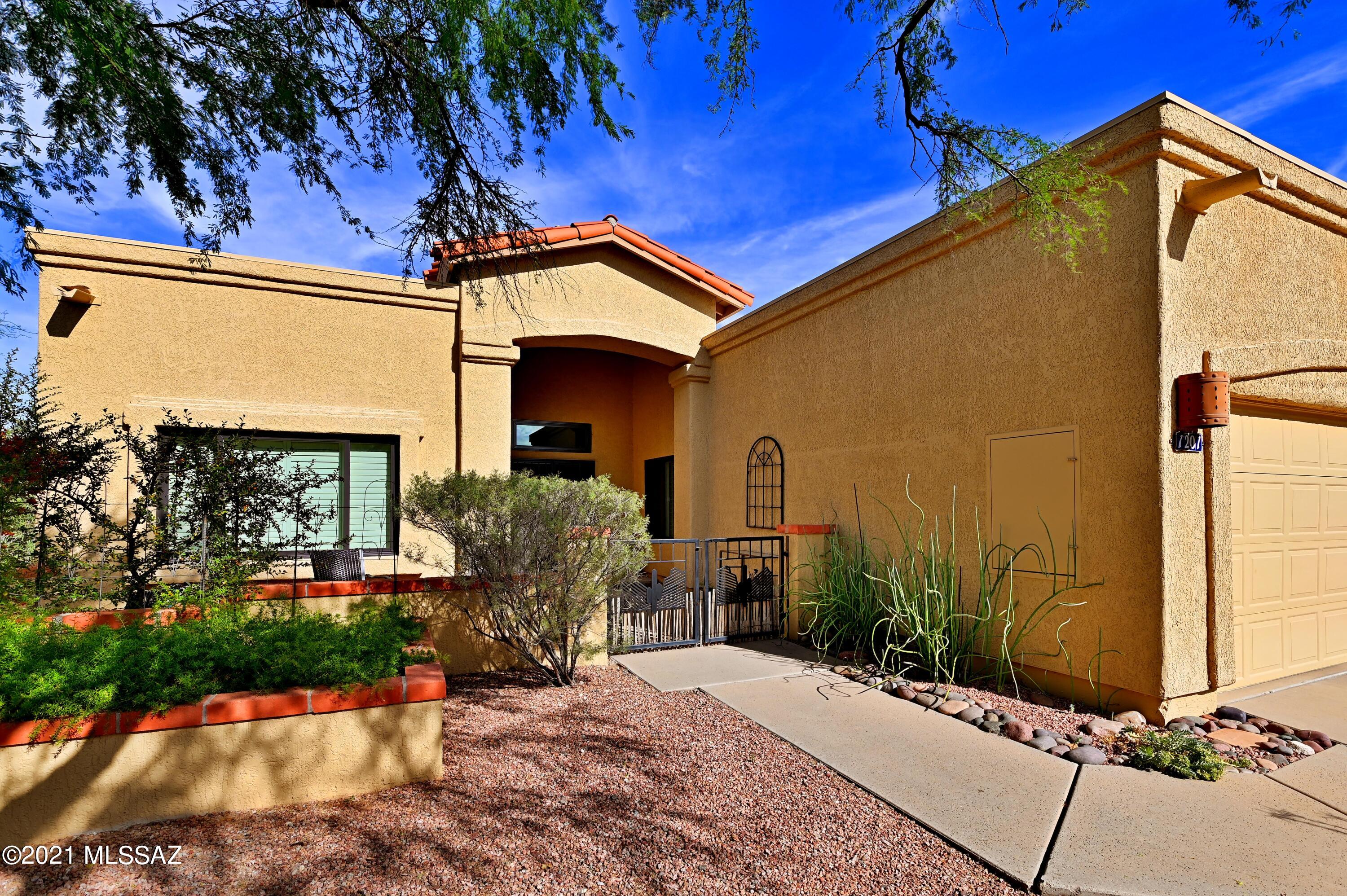 Amazing El Conquistador townhome with privacy + mt views and more. This is a highly sought 3/2 (1516sf) SW style with a 2 car garage and oversized patio. Inside SW style through-out with satillo tile, tile countertops at kitchen/ baths, plus more. Great room plan with an impressive fireplace plus split bedrooms offer privacy and functionality. Outside the home sits on a ridge top with Oro Valley, Tortolita & Catalina Mtn views. An oversized patio with extensive brickwork makes for comfortable outdoor living/ entertaining. Located in one of the most naturally beautiful parts of Arizona with easy access within Oro Valley makes this a highly demanded home. Some furnishings convey, ask for details! Priced to sell schedule your showing today.