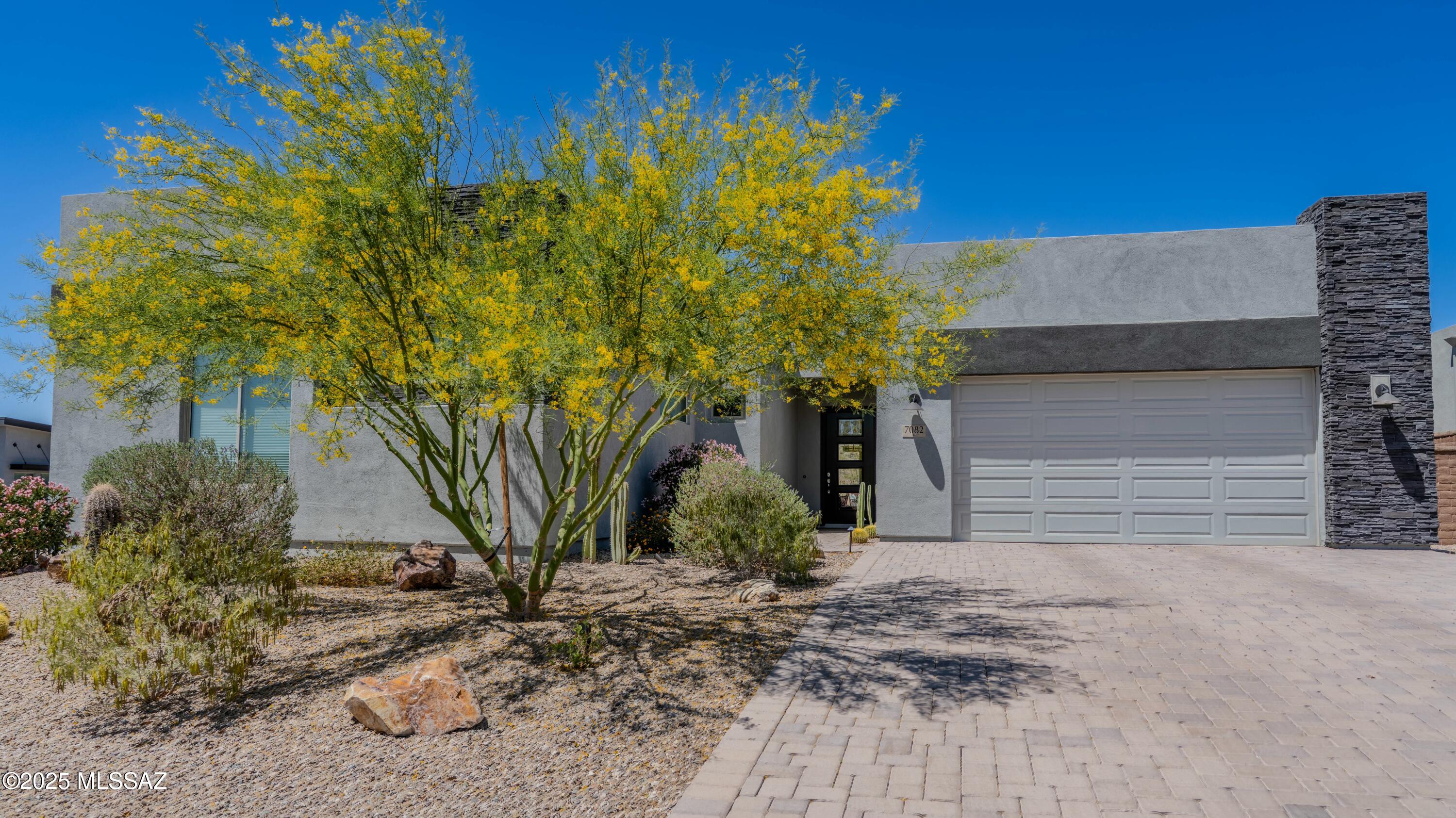 Stunning contemporary home in the highly sought after community of Boulder Bridge Pass III at Dove Mountain. Incredibly private homesite with NO NEIGHBOR BEHIND YOU- open Desert space & forever views. Plenty of room for a pool! This better-than-new 4  bedroom, plus office home offers designer finishes, a neutral color palate and a gorgeous professionally landscaped backyard, with unmatched mountain views. The entry foyer opens up to the Great Room with dramatic window walls that bring the outdoors in.  A chic gas fireplace becomes the focal point, perfect for entertaining or a cozy night in.  The chef's kitchen is complete with high end appliances & luxury workspaces. The Primary Suite offers large windows with mountain views and a beautifully designed spa like bathroom, complete with an oversized walk-in shower. Membership to The Golf Club at Dove Mountain is INCLUDED! Enjoy access to luxury amenities, fitness facilities, social events & more!!