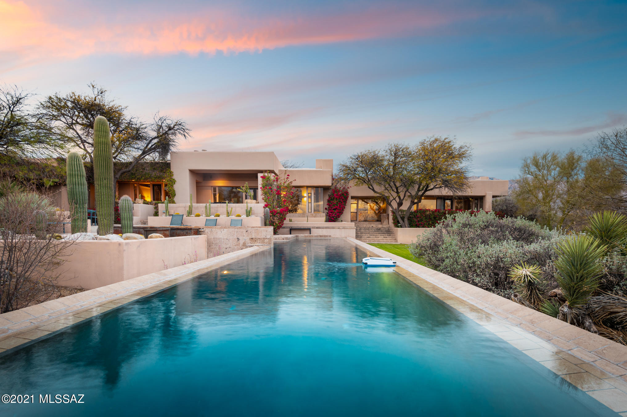 Your own resort, a short walk from Hacienda del Sol! Impeccable contemporary Foothills home featuring a split floorplan that offers natural light and incredible views from every room through floor-to-ceiling windows. Custom touches throughout, including Canterra stone floors, carbonized bamboo decor elements, limestone tile, vaulted wood-beam ceilings, Sonneman modern lighting and Kichler fans. The chefs kitchen features Subzero and Wolf appliances. A spa-like owner's bath is the perfect place to relax in the jacuzzi tub or walk-in shower. The spacious owner's suite has private access to the resort-stlyle backyard, which boasts an outdoor kitchen and bathroom, lush lawn, hot tub and infinity lap pool, with calming waterfall. The 4th bedroom is an ideal office, complete with a private patio and Catalina mountain views. Bathrooms have been updated with limestone tile walls and backsplashes, high-end fixtures and LED lighting. The media room offers Catalina Mountain and city light views and plantation shutters allowing the room to darken to enjoy a movie night! It could also be used as an additional bedroom or office. Private, tiered front patio off of the dining area is perfect for those quiet mornings with the soothing fountain!