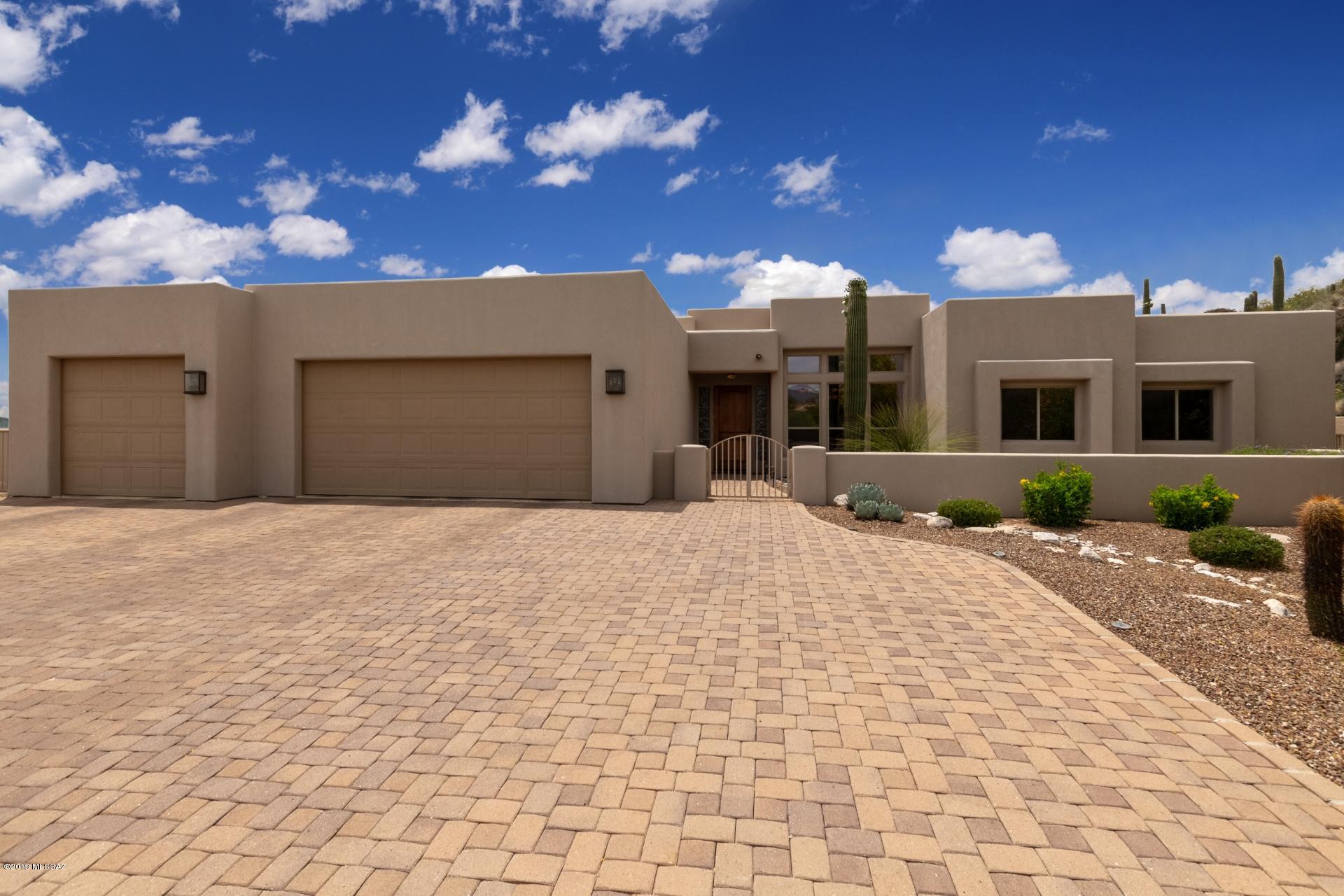 Seller will accept/counter offers between 795,000 & 835,000.  This glorious single story home sits nestled in the amazing Catalina Foothills & the gated community of River Gate Estates.  Upon entering you will be delighted w/ the fine custom features of this home. From the  beautiful tile flooring, exposed wooden beam columns & Vegas, cozy fireplace in the family room, to the spacious living area with custom wet bar & wine pantry,  tons of natural light & an open floor concept! The kitchen boasts a breakfast bar, granite counter tops,  ample warm wood cabinetry,  & dual ovens. The formal dining room is just off kitchen, adjacent to the  walk-in pantry and spacious cabinet lined laundry room. Bedrooms are large w/ great closets & Master Bedroom has a delightful separate sitting area. The covered back patio overlooks the expansive backyard that is comprised of a separate guest house that is equipped with it's own gated court yard along with a living area, bedroom & bathroom.  The backyard continues to captivate with a custom gas fire pit, outdoor fireplace, pristine private pool and spa w/water feature, custom BBQ  bar and wonderful desert landscaping! Such an ideal setting for relaxing or entertaining with friends and family! The 3 car expansive garage is full of custom cabinetry.  See beautiful scenery of mountain tops and city views from multiple areas around this fine home. This is it!