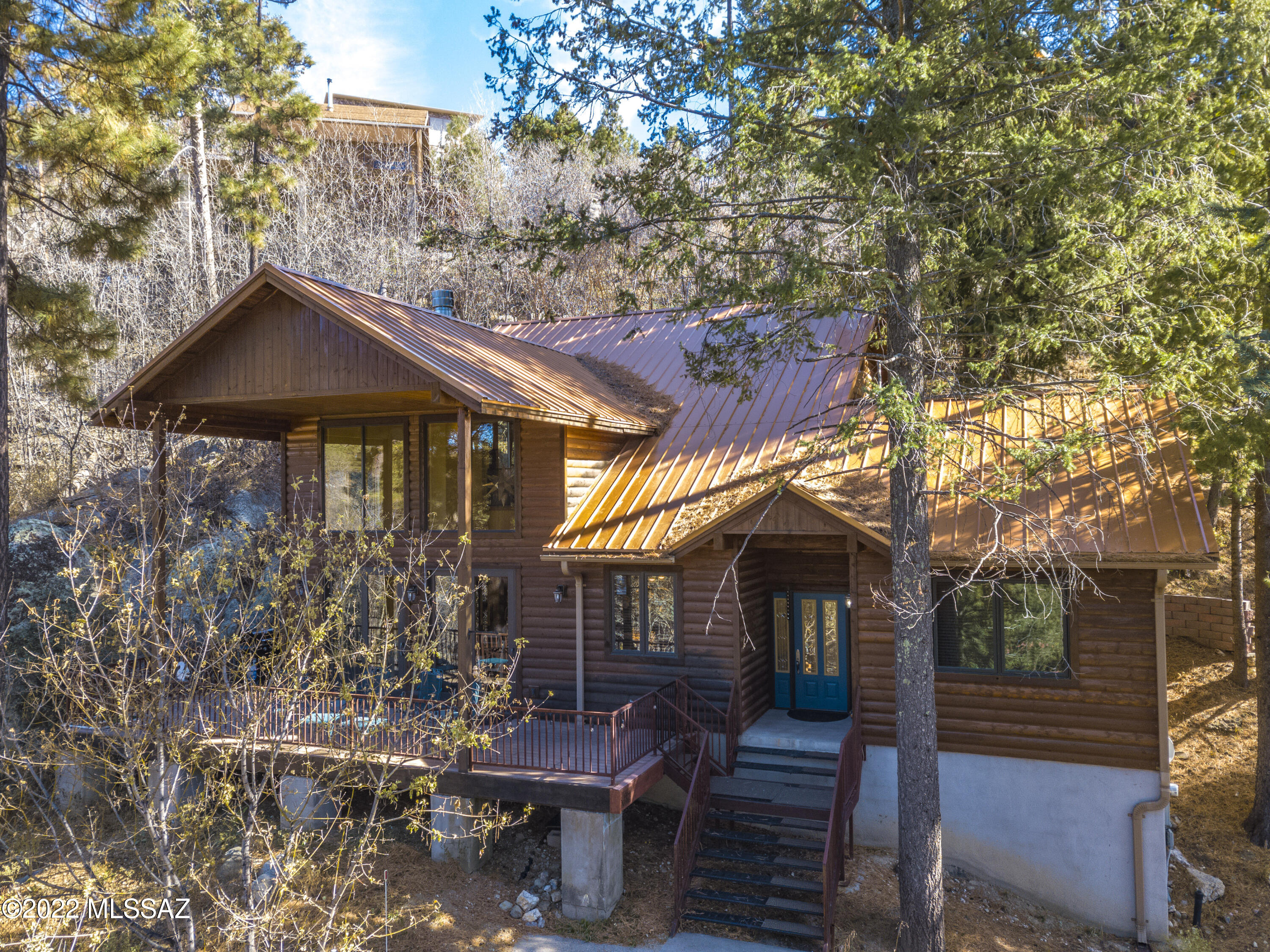 Year-round use cabin features a bedroom and full bath downstairs plus a private bedroom with full en-suite bath
and an additional sleeping loft upstairs, sleeping 8 or more comfortably. This 2-level cabin features a generously sized elevator as well. The lower level great room is ample with a dining area surrounded by glass doors leading onto an outdoor deck, a living room
with wood burning fireplace, and a secondary sitting area. The full sized kitchen has stainless appliances, a pantry, and an island with plenty of seating incorporated into the main living area. There is a large utility closet indoors, leading to a cellar with additional storage space. The concrete  driveway from the street has plenty of parking space, and the roads to this cabin are open year-round for residents... Convenient to Summerhaven town without experiencing the commotion of the main drag. The home sits on a total of 3 tree-studded lots with an abundance of privacy and quiet. This cabin is being sold turn-key so it's truly move-in ready!