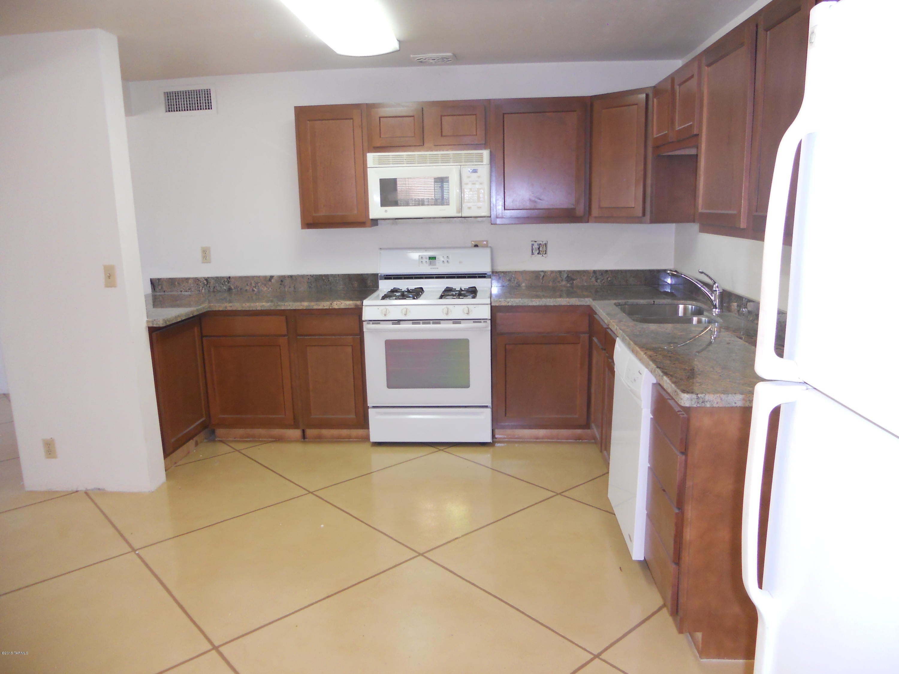 COMPLETELY REMODELED CENTRAL CHARMER.  GRANITE COUNTER TOPS NEW APPLIANCES.  SPACIOUS MASTER BR.  NEW WOOD FLOORS IN ALL BEDROOMS.  NEW ENERGY EFFICIENT WINDOWS  LARGE FENCED BACK YARD WITH GATE ACCESS TO ALLEY ON WEST SIDE OF PROPERTY.  GREAT ACCESS TO U OF A STRAIGHT DOWN MOUNTAIN.  WASHER & DRYER HOOKUPS  SECURITY SYSTEM INSTALLED. OWNER WILL GIVE PREFERENCE TO NON-SMOKERS.