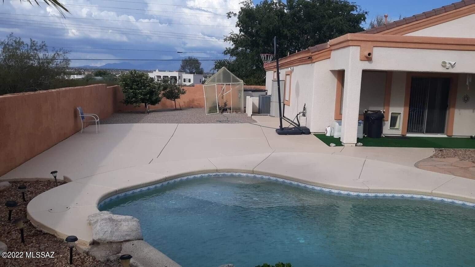 PRICE REDUCED 10K This is a must see home in a coveted subdivision. Largest lot in the neighborhood setting on 0.83 acres. 3 car garage, custom swimming pool w/ waterfall & safety pool cover, artificial grass in the back for low maintenance, multiple fruit trees with breath taking views of Sombrero Peak and the Catalinas.  There is solar and it is owned, no need to worry about a lease. Water softener is a welcome addition. Solar screens on all windows, ceiling fans throughout, doggie door in master. So many possibilities on this huge nearly one acre lot. Beautiful sunsets & sunrises.