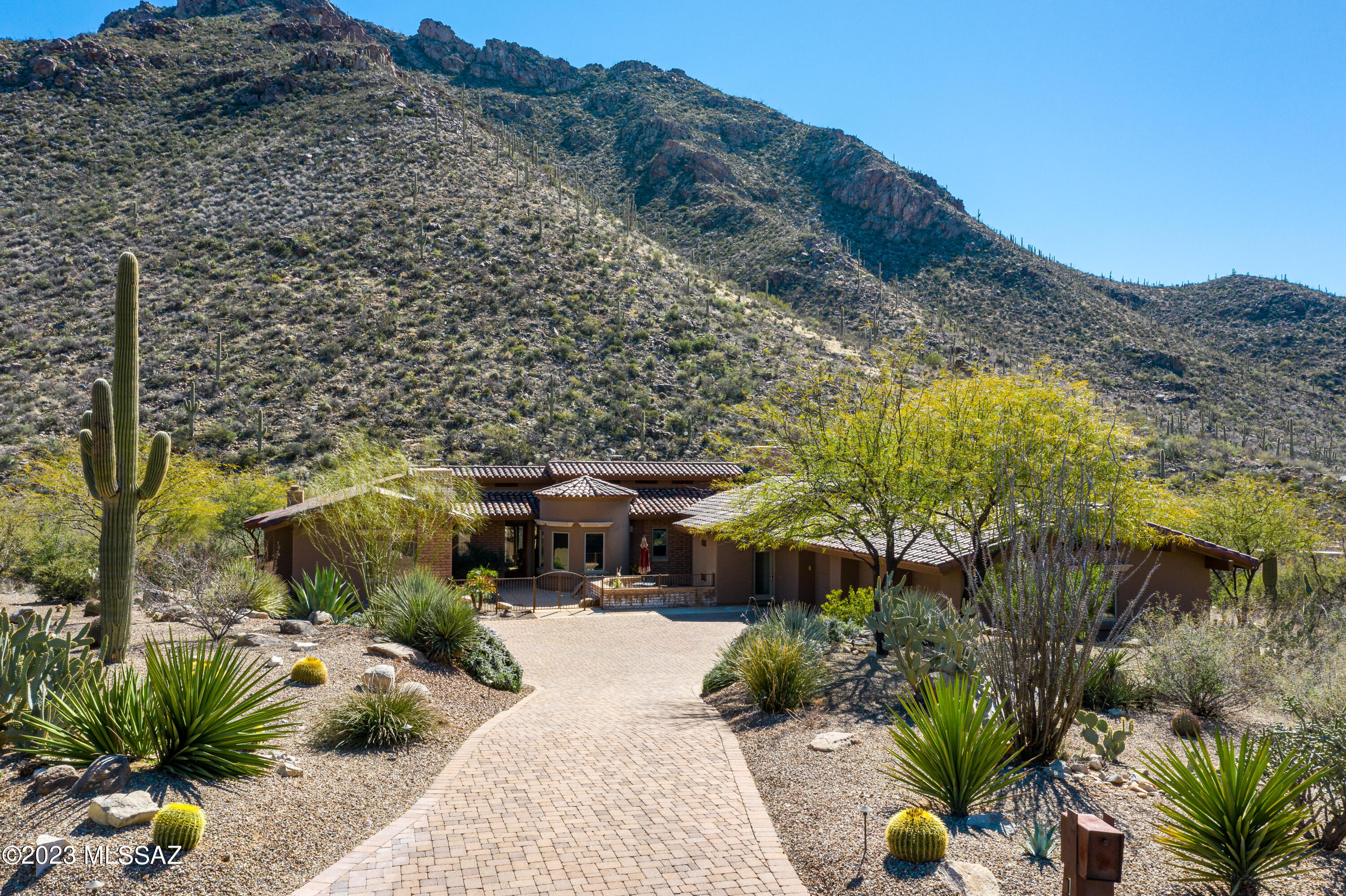 Mesmerizing saguaro studded mountain views from this elegant stunning custom home nestled on a very private  lot in gorgeous Canyon Pass at Dove Mountain. Exquisite fine features include rich wood beam ceilings, sprawling gourmet kitchen w/stainless steel appliances,  elongated island, unique granite countertops, rich/gorgeous stained concrete floors, abundant custom woodworking just to name a few. Remodeled pool & spa with expansive outdoor living areas including new fireplace w/raised planter box. Pool  upgrades include: newer pool/spa heater, upgraded  AquaLink controller system, variable speed drive motor. Relaxing master bedroom w/sauna shower & soaking tub.Expansive, oversized 3 car garage w/storage. 4 bedrooms or 3 bedrooms + office/den.  Dual master bedrooms - both w/fireplaces.