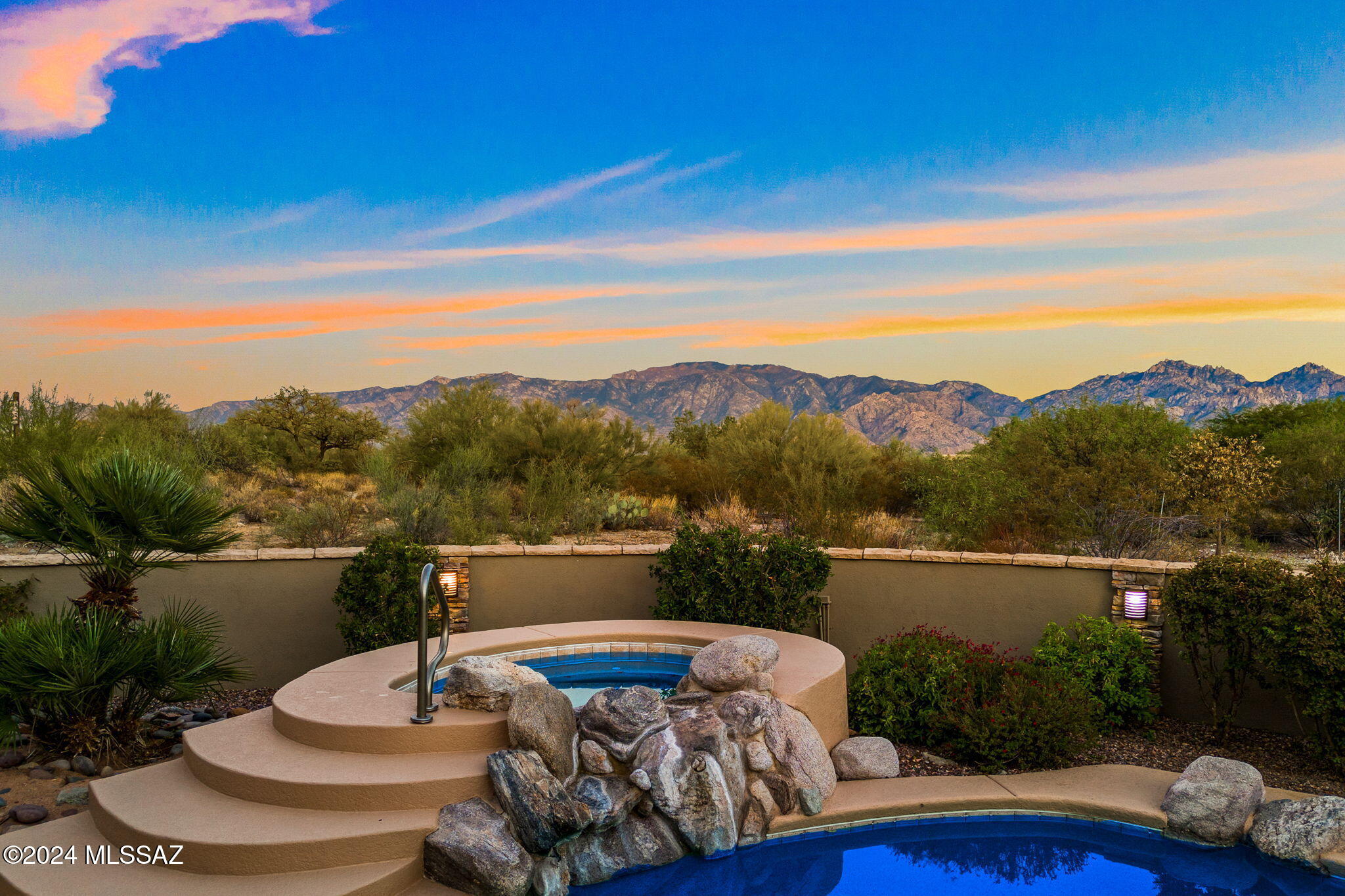 AWE-INSPIRING MOUNTAIN VIEWS located within the coveted guard-gated community of Stone Canyon. Meticulously updated to blend its timeless Old-World Charm with modern elegance including but not limited to all new luxurious quartz countertops, frameless glass shower enclosures, sinks, plumbing fixtures, light fixtures, ceiling fans, outdoor barbecue, shower tile & paint throughout. Interior features include a formal entry, living room & dining room, open kitchen/great room with breakfast nook, cozy stone wrapped fireplace & a gorgeous tongue & groove ceiling with hand hewn timbers. The chef's kitchen encompasses brand new JennAir appliances, a large island, Sub Zero refrigerator & an abundance of cabinets. The split floor plan includes 4 bedrooms with ensuite bathrooms, powder room, & travertine floors throughout. Additional features include an owned solar system for substantial savings on home electricity, solar & gas pool heaters for year-round use & an oversized 3-car garage. The private east face backyard is an entertainers delight with a sparkling pool/spa, stone water feature & sought after Catalina Mountain Views. Exquisite living experiences within this private community include Jay Morrish designed world-class golf course (membership not required), exceptional dining, entertainment & a health & fitness center with pickleball, tennis, 2 pools, & fitness equipment all within a short distance. This remarkable find will not last long. Call listing agent to discuss scheduling your private viewing.
