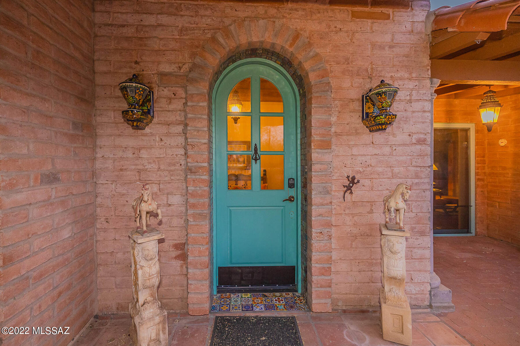 Authentic, Old World Rustic Mexican Adobe home on 1.49 Acres with no HOA!  The Saltillo tile floors extend throughout most of the 2801 Sq Ft home with the exception of the carpeted 3 Bedrooms, each with their own Private Bath. The Mexican Tiled Fireplace is the centerpiece of the Living Room and the Mexican Tiled Mural is the focal point in the Dining Room. The Kitchen boasts a Wolf gas Cooktop & Dacor Dual Convection oven.  Just off the Kitchen is the Library/Sitting room with Library Ladder, Shelves and Pillars.  And don't miss the massive Laundry Room with Cabinets, a Laundry Sink and additional Refrigerator.  Quality construction is found throughout with all Anderson Windows & Doors and even an owned Solar System, Fully Paved Driveway, walled Courtyards both front and back, Water Feature, Green House, 2 Car Garage, Putting Green, Star Gazing Balcony are included in the long list of amazing features to be found here.  Please come see!