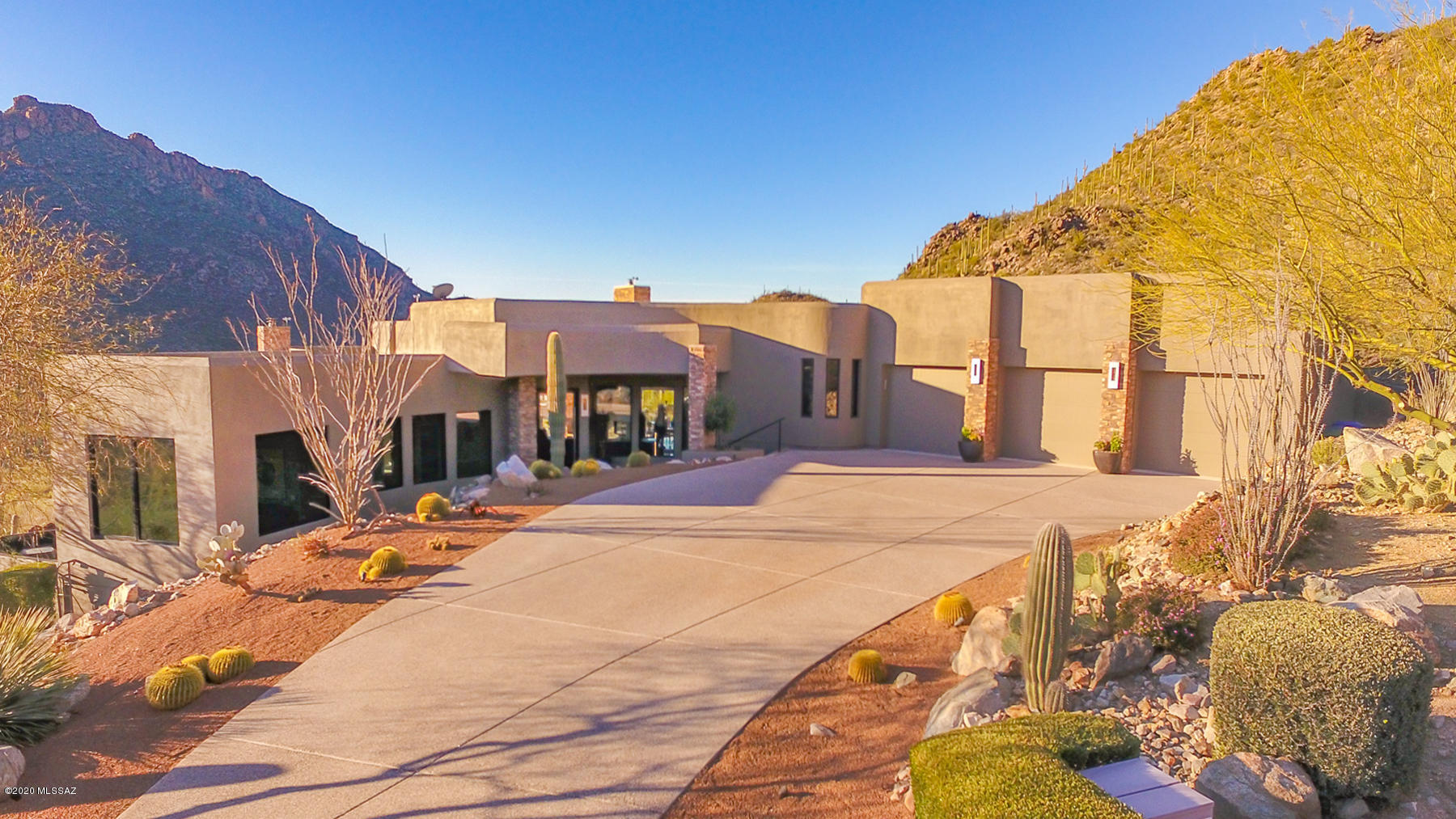 Spectacular Greg Simmons Contemporary sitting on top of pristine, private Canyon Pass. Stunning natural setting w/ rock outcroppings & Saguaro studded hillsides. Simmons brilliantly blends Modern, luxurious simplicity w/ rugged nature via walls of windows & Retractable Sliding Glass doors. Premium finishes: Blue Gascon Limestone floors, minimalist Neff Kitchen/Wetbar Cabinets, Ceasar Stone counters & Premium Appliances: Sub-Zero 48'' Fridge, Wolf Duel Fuel 48'' Range, Meile Espresso Maker & Liebhorr Wine Coolers. Spacious, Spa-like Master Suite w/ Dual fireplace. Ideal outdoor living w/ panoramic views, Travertine accented negative edge Pool/Spa, 48'' Gas Grill, Integrated bar/fireplace & expansive Patios. 5 Minutes to GC of Dove Mountain, Ritz Carlton DM & Gallery GC. Owner is AZ Realtor.