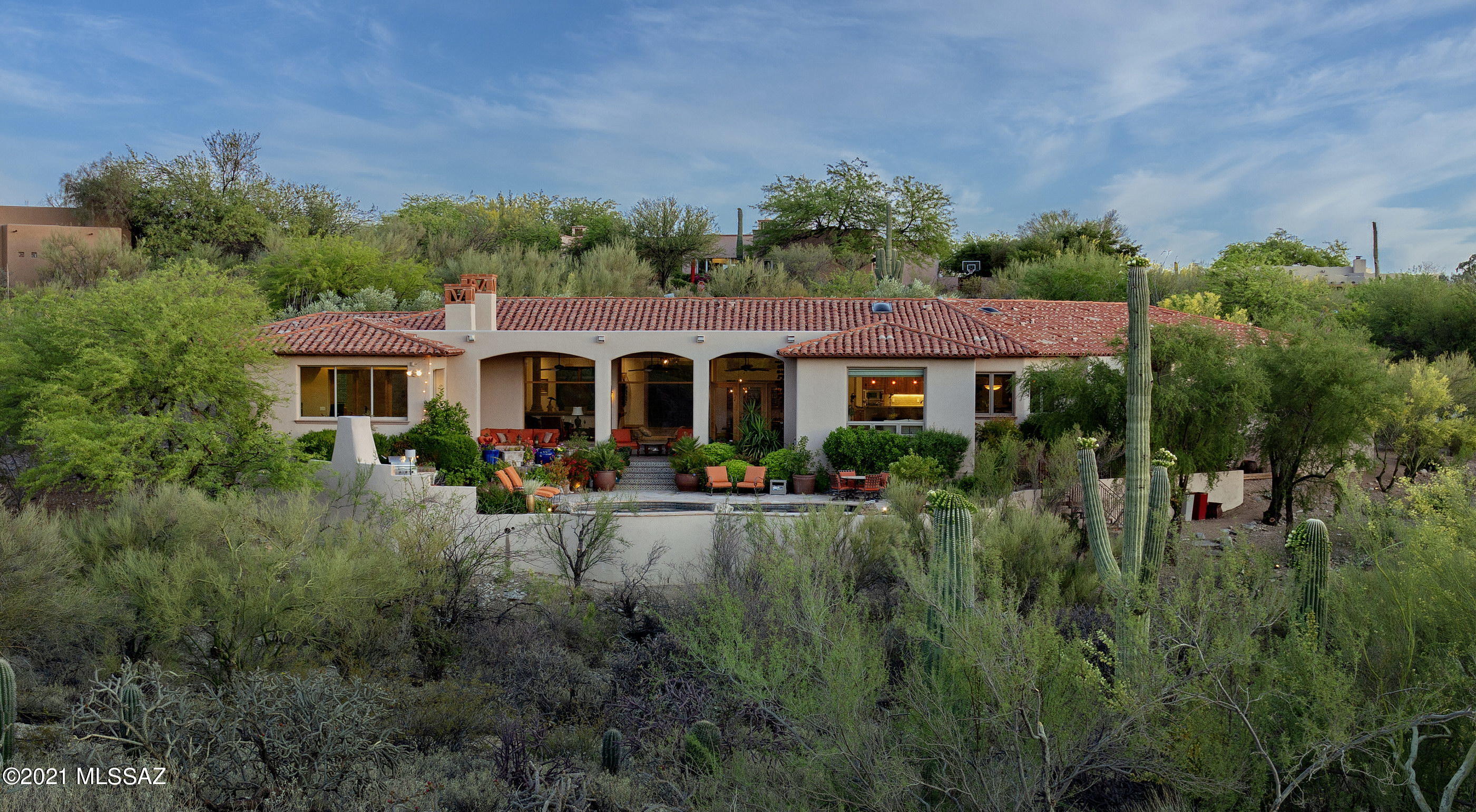 Enjoy some of the most dramatic Catalina Mountain views, stretching out over the lush greens of the 6th fairway of the prestigious La Paloma golf course. This thoughtfully crafted and timeless estate property, features classic detailing with a modern ease. Upon arrival, an air of grandeur pervades this incomparable residence, privately nestled within the surrounding desert landscape, adding to the feel of this sophisticated estate. Enter through a private courtyard into a high design interior space that complements and reflects the vernacular. The main entry foyer, with soaring ceilings heights and sumptuous mesquite floors acts as the central hall, establishing the main connection point of the home... opening onto the formal living and dining rooms, with scaled picture windows strategically placed to enhance the dramatic view corridors.

Complementing this perfectly executed split bedroom floor plan with fluidity and openness that spills out onto the tranquil grounds at every turn. The heart of the home is the fabulous reimagined chef's kitchen featuring top end fit and finish, which includes a large center-island, granite countertops, ample storage and a pro series stainless steel appliance package. 

Sequestered on the East end of the residence is the owners suite, with a custom walk-in dressing room, luxuriously finished spa-like bath, equipped with an office/workout flex space and walk-out patio, perfect for enjoying the breathtaking mountain views. The balance of three bedrooms are sequestered on the West wing of the residence, each with direct access to an adjoining en-suite bathroom, perfect for families and guests alike. 

The elongated veranda connects the shared living spaces, with a series of doors coordinated to tie the interior rooms to the spacious outdoor living environments, resulting in a juxtaposition of private and social spaces. Layers of elevated patios and strategically placed vegetation cause an explosion of color, light and shadow, creating the perfect framework for the sun-drenched pool, all designed to enjoy the unobstructed Catalina Mountain and Sunset views.