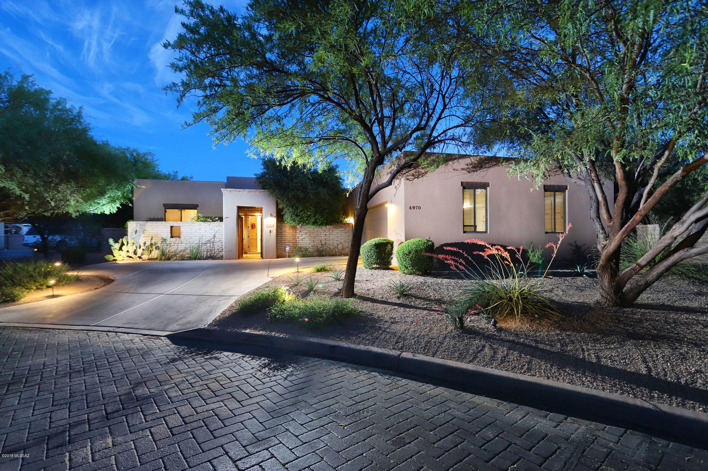 Inviting front courtyard leads you into this beautiful home in coveted Parade Grounds, convenient to everything. Open floorplan with high ceilings, granite countertops, stainless steel Viking and KitchenAid appliances.  Professionally designed landscaping in the very private back yard with built in grill, pool, spa, and waterfall. Concrete floors throughout with carpet in the bedrooms. Tile and quartz in the bathrooms. Over sized garage with extra storage cabinets. Gated neighborhood with beautiful neighborhood park area with grass and mature trees. Easy access to river walk hiking and biking paths.  Owner/Agent.