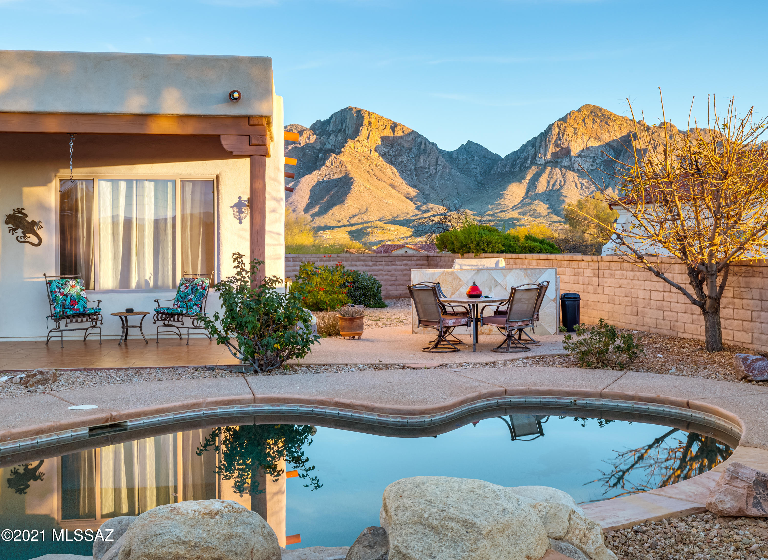 Sombra Homes Contemporary Southwest in Gated Pusch Ridge Vistas. Single-story 3,420sf 4BR/3BA w/circular dining area, family room off kitchen & separate living room. Front Courtyard has amazing Catalina Mountain Pusch Ridge views. Open family room has fireplace w/custom wood mantle & media center w/tongue & groove wood ceiling w/exposed viga beams. Kitchen has granite counters, stainless appliances, 5-Burner Gas Cooktop, Center Island, walk-in pantry, large curved breakfast bar & casual dining area. Newer interior paint/carpet. Spacious Master suite has sitting area w/fireplace, jetted tub, large walk-in shower, separate vanities & his/her walk-in closets. Lush back yard has various citrus, roses, palms, grass,7' deep pool/spa w/rock waterfall & built-in BBQ. Post Tension Slab.3-car garage