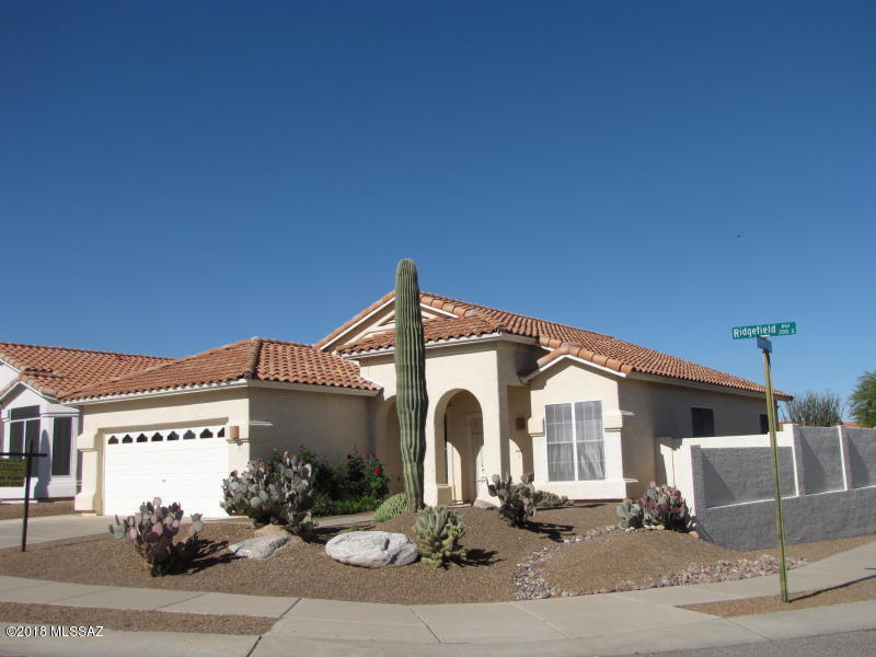 This is a beautiful home in Sonoran Heights.  It is on a corner lot.  Vaulted ceilings to give you a bright open feel.  Tile in all areas except the 4 bedrooms.  Window coverings throughout less than 3 years old.  Stove and microwave less than 2 years old with corian counters in the kitchen.   Large master bedroom and an inviting master bath with a garden tub, separate shower stall and a walk in closet. 
The back yard is a wonderful escape with a comfy patio, fruit trees and a dog run.  THE HOT TUB CONVEYS! This is the ultimate ''move-in ready'' house. This will not last! This is HOME!