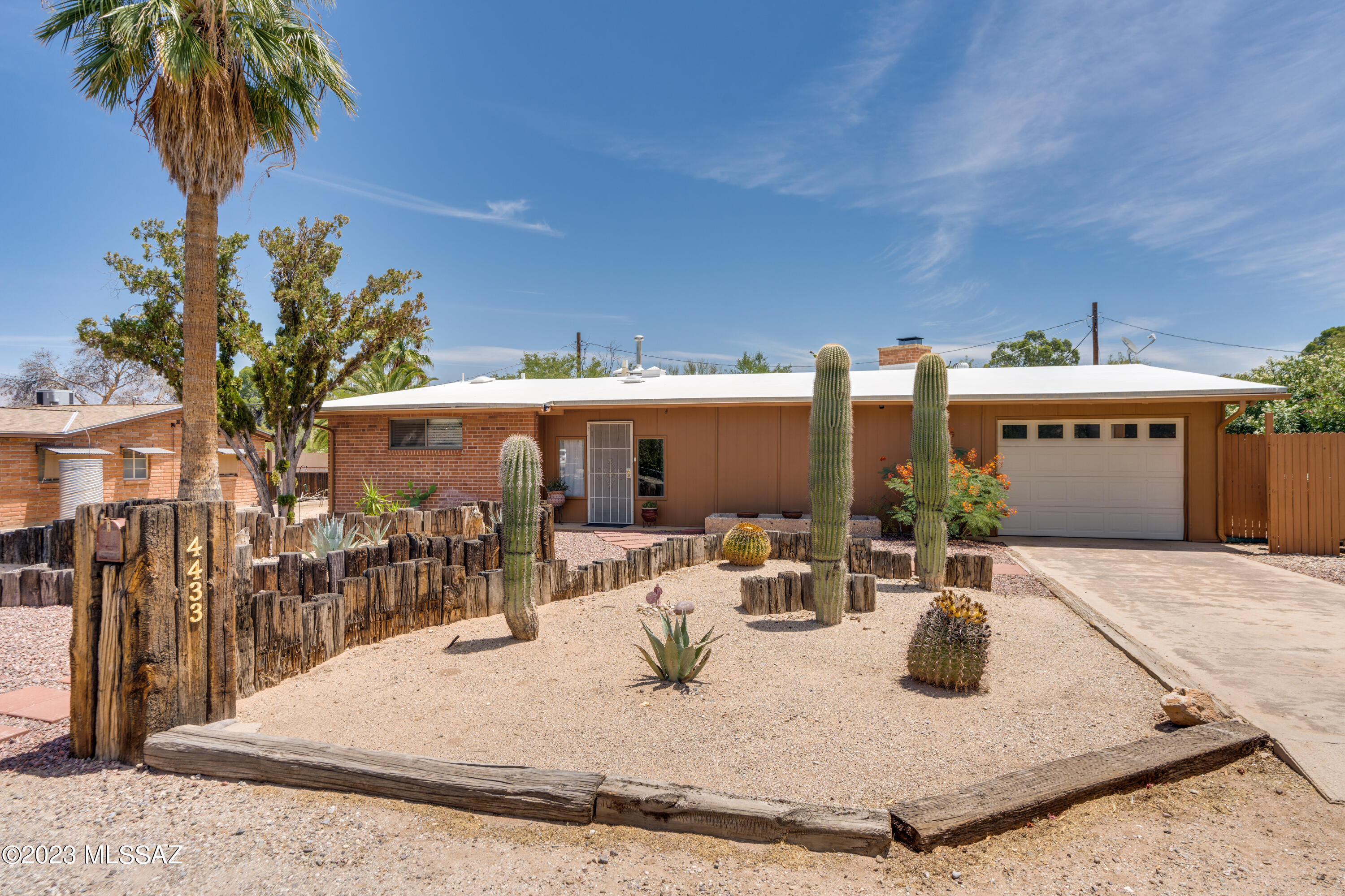 Beyond charming mid-century home in great central location! Vaulted ceilings with wood beams, walls of windows, open corner fireplace, abundant tile flooring. Large master bedroom with tile shower, walk in closet. Built-in bookcases in one bedroom. Open kitchen with glass front cabinets. Arizona room across front, extended covered patio in back. Large walled yard with extra storage/work area. Truly a must see property!