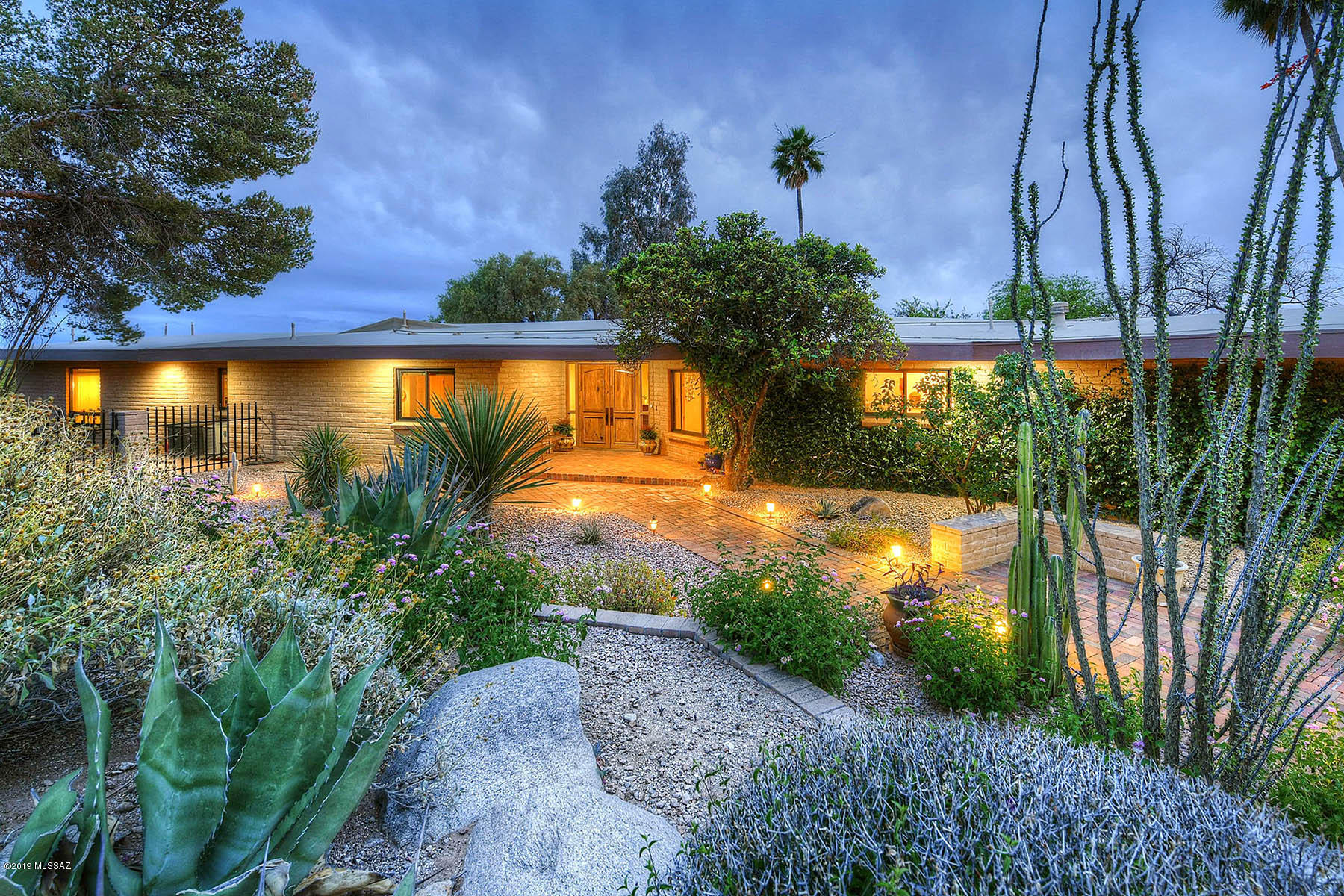 Charming Mid Century Modern Burnt Adobe 2AC
hilltop setting. Mt & desert vistas! Private! Horse
Property.Beautiful landscaping-Gated courtyard entry. Extensively remodeled over the years retaining its heritage with Today's Finishes.Hardwood floors-Quality Windows+
Doors-Recessed Lighting throughout-A True Chef's Kitchen: Quartz Counters, Custom Cabinetry w/Deep Drawers,Display Cabs,Double Ovens,Gas Cook Top,Island has Prep Sink-
Walk In Pantry. Living Room features a masonry, wood burning 
Fireplace.-Formal DR-Family Room opens to Kitchen/Breakfast area-Super built-in Cabinets+
shelves-Spectacular  Mst Ste: French Doors to Private Patio + Special Garden that includes Tortoise  Enclosure+Pond-Rincon Views.  Many Glorious OutDoor Spaces-Sellers being transferred. 1 agent related to Sel Beautiful master bath double vanities, newly remodeled walk in shower, garden tub and very large walk in closet.  Three additional
bedrooms are good size, one has a built in desk so could be an
office.  The entire house has excellent closet space in every room,
halls, etc.  A real laundry room with utility sink, walk in closets & cabinets.
Bonus Room off the garage is separately heated/cooled perfect exercise room, playroom or office-  built in desk with granite
counter top.   Resort like backyard, beautiful pool with water spouts is  separately fenced. There is a pool heater but it is seldom used -conveys AS IS. Covered porch, low care but lovely landscaping.  Artificial grass, vegetable garden,  play equipment
stays.  Drip system was recently re done.   Outside of the enclosed yard is a fire pit area, horse shoe court and a storage shed.
Property sits above a wash...great for exploring!  And yes, you can have horses.