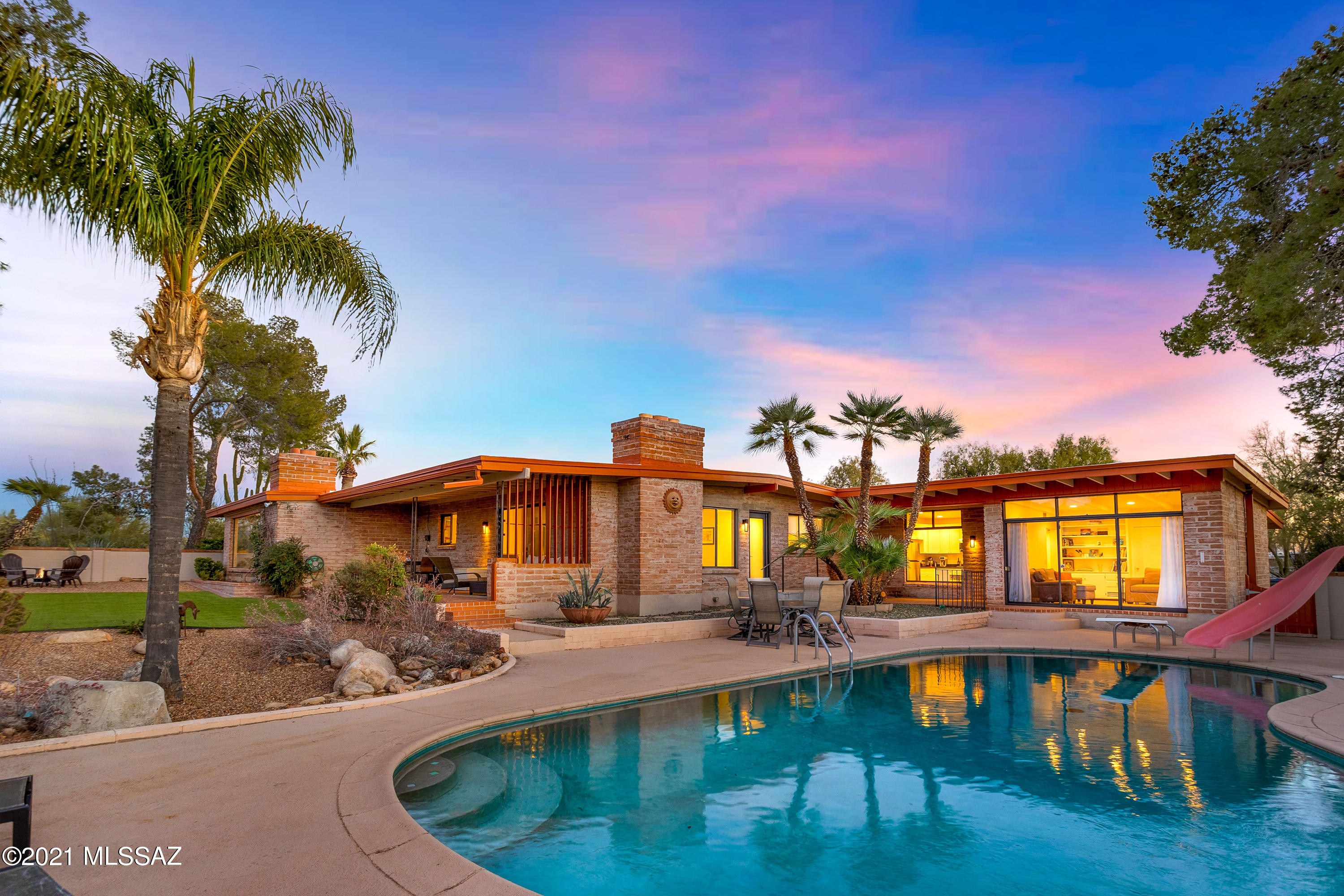 Beautiful Mid-Century Adobe Home in Oracle Foothills Estates with Awesome Guest House. PERFECT TUCSON LOCATION close to everything wonderful! 2.43 Acres of privacy, natural desert, backyard oasis, lush vegetation, restful side yard, and large fun recreational pool. Complete Designer
Remodel. Spectacular panoramic views of the Catalina Mountains, Sunsets, and Canyon Wash. HUGE GUESTHOUSE features 1 or 2 bedrooms/living room, full kitchen, bathroom, separate entrance, parking area laundry facility. NO HOA. Opportunity for Airbnb. Storage room and workbench room. This property offers immense character, soulful lifestyle, and gracious living. Open Enrollment available to many surrounding schools. Great shopping, restaurants, hiking near by. Seller is licensed realtor.