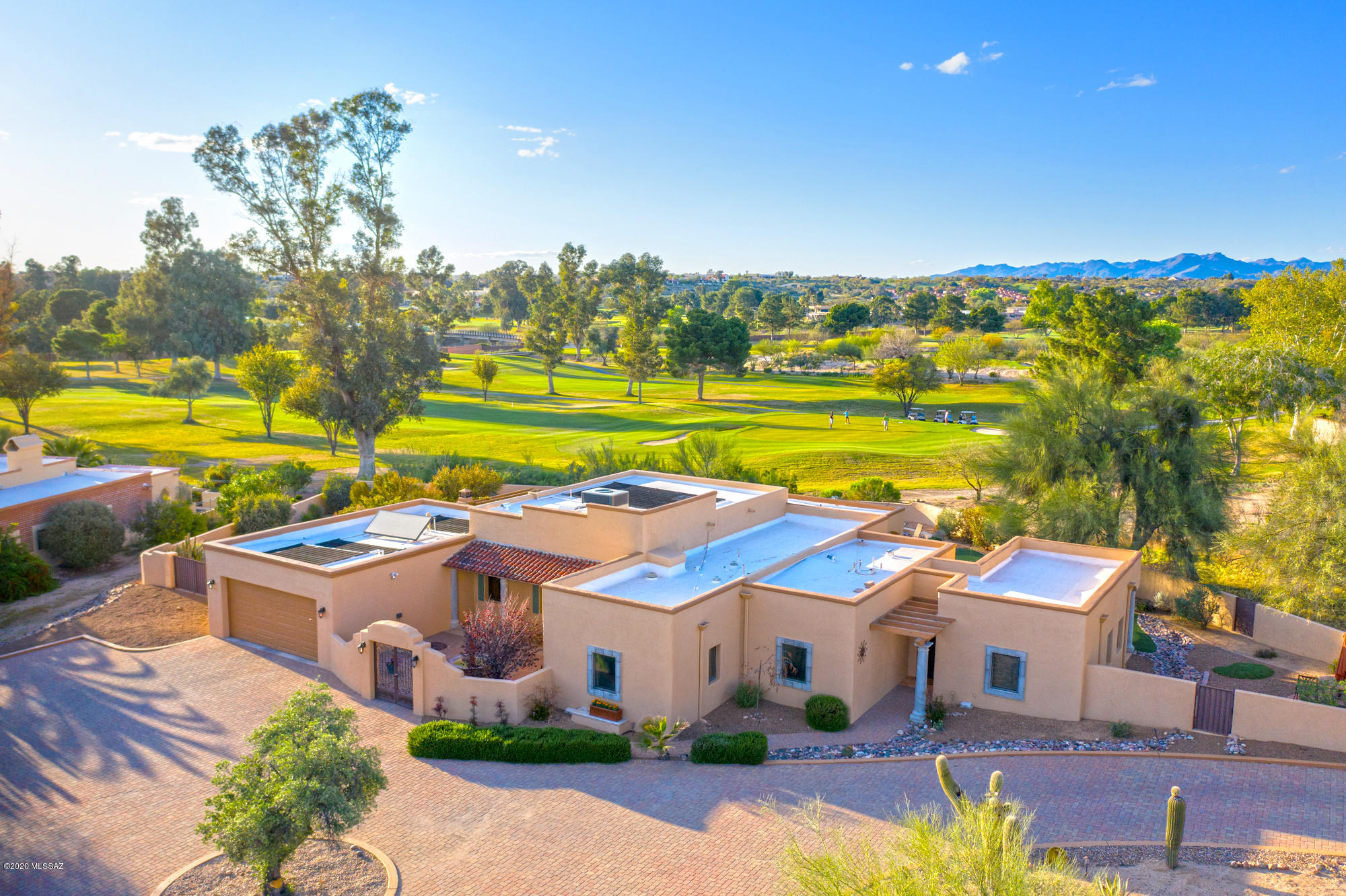 Absolutely beautiful home sitting on a large 1.13 acre premium golf course lot in the esteemed Tucson National Estates! Sitting at the 16th green of the Catalina Course, the surroundings both indoors and outdoors will have you enjoying  being home in your own private retreat!  A generously paved circle drive brings you to the gated courtyard, complete with fountain and large double door entry.  The main house has 3 of the 4 bedrooms and 2.5 baths.  The open great room floor plan provides a formal dining (if desired), exquisitely adorned bar area, breakfast nook, generous island, granite counters, travertine flooring and rich cabinetry and built ins.  The master retreat provides its own private courtyard with gorgeous tiled outdoor shower, large walk in closet, dual vanities, garden tub and steam shower.  The guest casita is connected to the main house yet has a separate entrance, kitchenette and 3/4 bath. The backyard is truly a resort setting - large covered patio, trellis patio, putting green, large solar heated pool and oversized spa, outdoor kitchen complete with pizza oven and additional open space within the property line should you wish to expand even more!  The current owners have added quite a bit of attention and updates throughout the home - new paint inside and out, all new carpet, completely re-wired the pool for total automation, new Ethan Allen window treatments, new AC units for both the main house and casita, new roof reseal with 10 year warranty and they are offering a home warranty with 2-10 Home Warranty that is good through 2/2021 and includes roof coverage for that extra layer of protection.  The garage has extra space for the golf cart and plenty of storage.  With views of the 16th green, the Catalina Mountains and our stunning Arizona sunsets, you won't be disappointed.