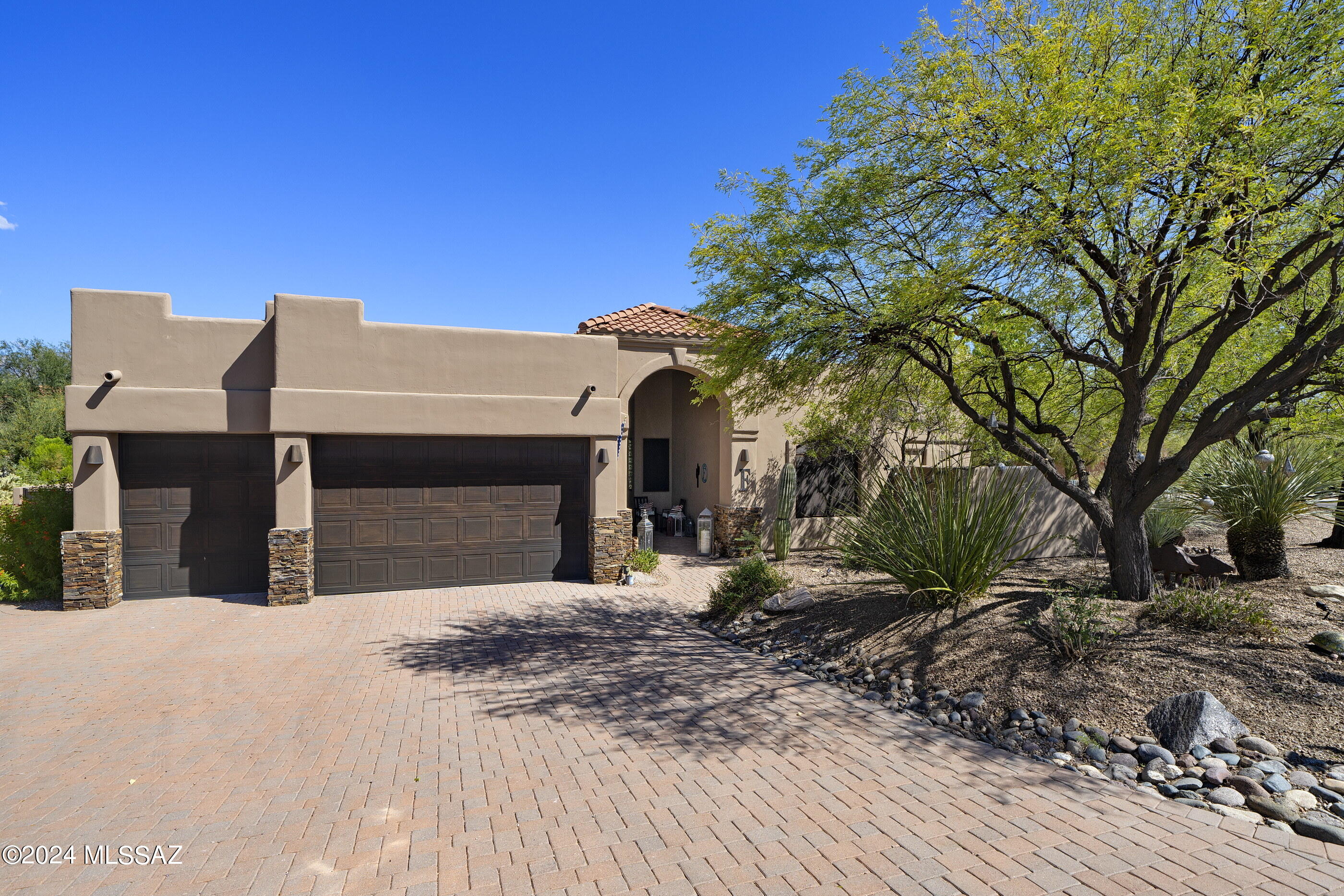 Enjoy Catalina Mountain views from this privately situated residence located in the highly sought-after Desert Vista community. This spacious, bright, and airy split bedroom floor plan features 3105 sq ft, four bedrooms, and three baths. Enjoy interior spaces that range from open and soaring to cozy and intimate. The layout takes full advantage of natural light, blurring the boundaries between the interior and exterior spaces. Before entry, you are greeted by the large outdoor foyer area, which establishes the main connection point of the home. Once inside, the pristine tiled floors float seamlessly throughout the space, subtly contrasting the custom-painted walls and textures.