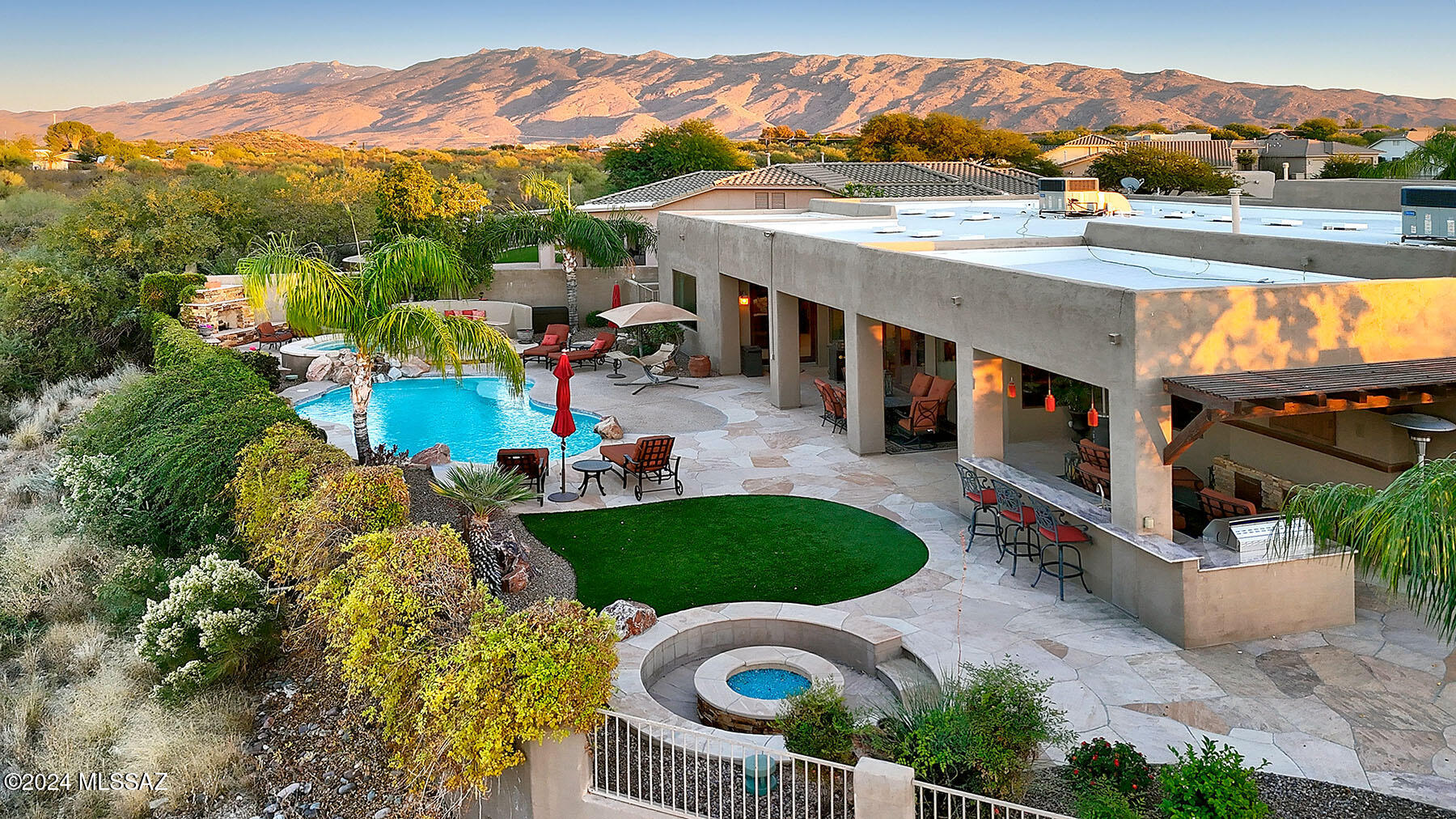 WOW!!! Resort style living! Nestled in a desirable half acre lot, this beautiful home boasts stunning mountain views, breathtaking sunrises and sunsets, and twinkling city lights. The 3300 square foot residence features a split bedroom floor plan, with a spacious kitchen that seamlessly opens to a great room, perfect for enjoying the phenomenal views. The outdoor living space is a dream, complete with a pool, spa, outdoor fireplace, fully equipped kitchen, a children's play area, and a basketball court. This property offers the perfect blend of luxury, comfort and endless entertainment opportunites for every member of the family!