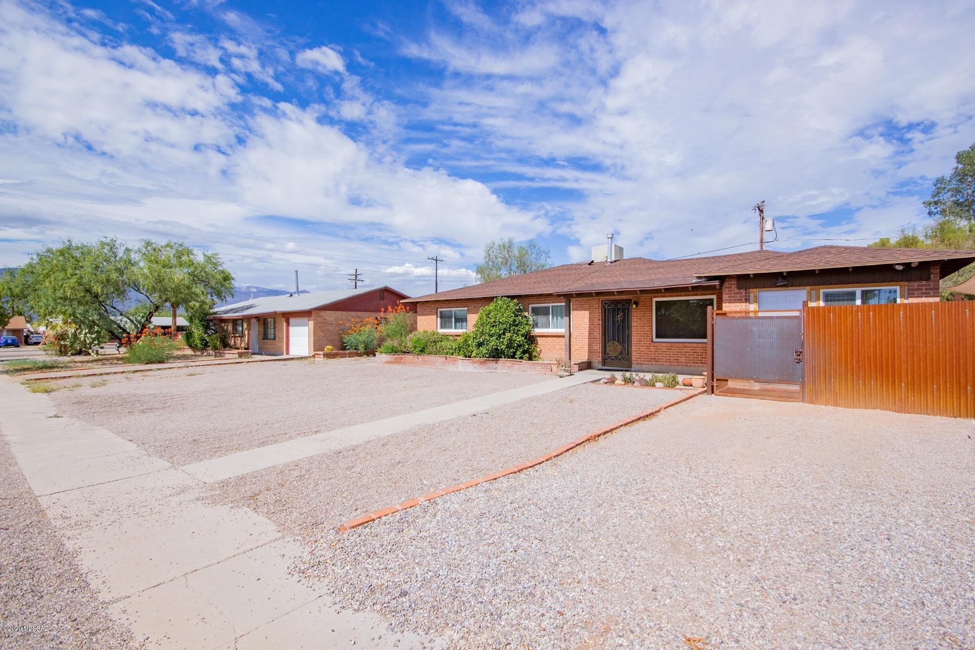 Beautifully appointed mid-century brick ranch with GUEST HOUSE! High end travertine flooring, Wood beamed ceilings and free standing fireplace in family room. Quiet den with space to work. Huge kitchen with tons of cabinetry and granite counter tops. Nicely redone bathrooms. Covered back patio.