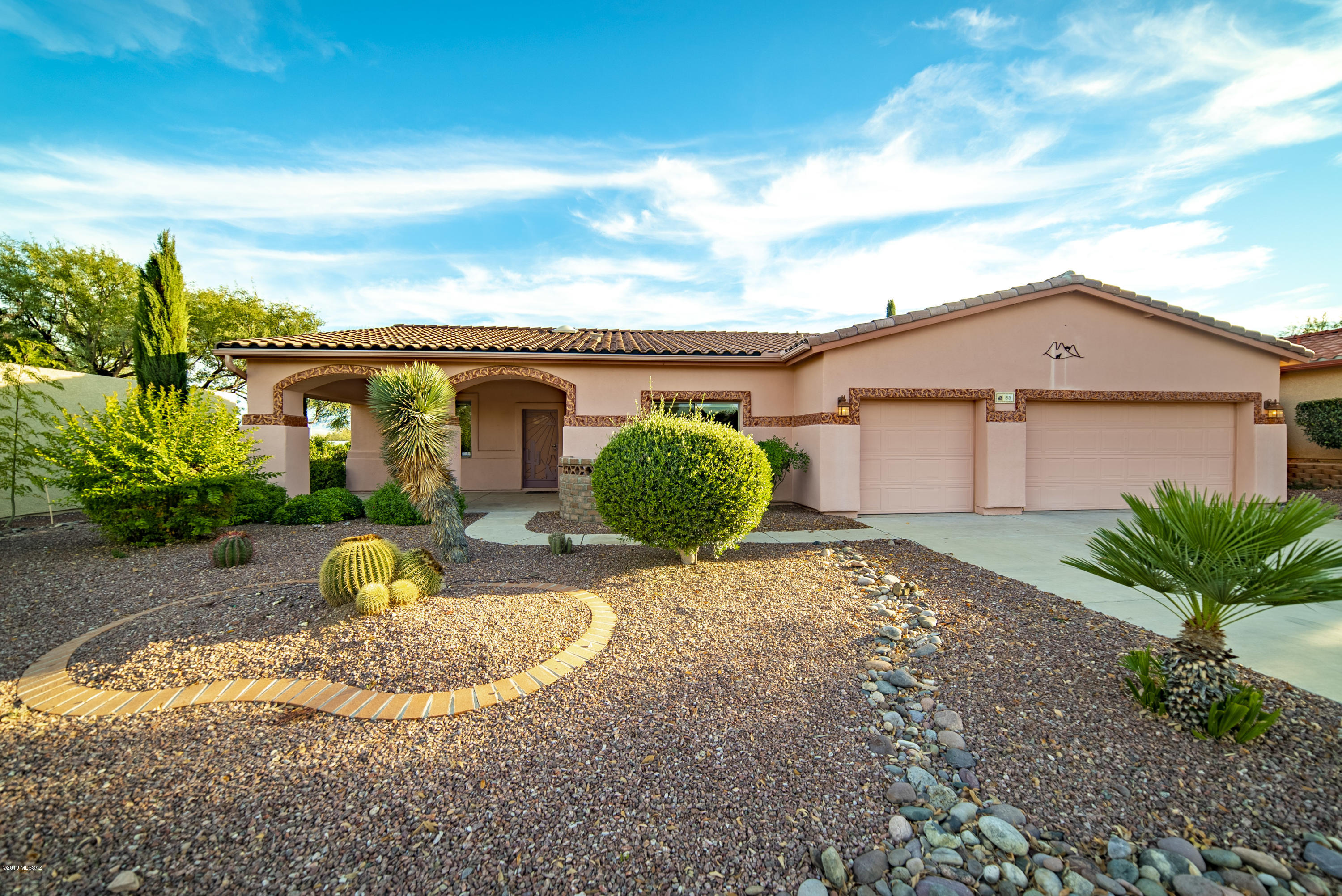 A home in Country Club Vistas with interesting curb appeal where contemporary combines with Spanish architectural arched openings.  A variety of palm trees, cacti and Cyprus trees compliment the homes setting.  Oversized diagonal tile sets the stage of the open great room and dining areas for numerous options to place furniture.  A convenient serving bar extends across the kitchen where you'll discover stainless appliances, easy-pull drawers, sink with a gooseneck faucet, a tumbled tile backsplash and abundant counter space topped with attractive granite.  The split bedroom arrangement with two guest rooms gives everybody the space they want.  The covered backyard patio makes a wonderful place to relax surrounded by swaying palms and luscious mature greenery.  And there is more - a 3 car garage and a separate storage shed to accommodate all your storage needs or perhaps even your own woodworking shop.   Currently not a member of GVR, but is available.