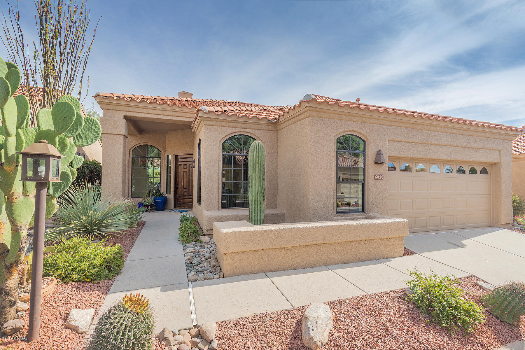 Rare opportunity in gorgeous, Gated Ventana Canyon CC. Spectacular 'Golf Villa' w/ Spanish influenced Renovation. Premium view lot offers unobstructed Mountain Views! Elegantly Re-Designed with warm colors and Spanish accents. Vaulted ceilings with walls of new Low-E Windows capture the pristine desert & rugged Sabino Canyon vistas. Seamless interior design blends warm textures & colors, providing a simple, elegant home w/ modern touches & inviting, charming spaces. Stunning Great Room w/ vaulted 18' ceilings connected to newly designed Gourmet Kitchen! New Master Suite w/ Pecan Hardwood & Limestone floors, new cabinets, counters and spectacular new Shower. 2 Bedrooms + Den w/ built-in desk, bookshelves and Murphy Bed. Large Garage fits 2 Cars + Golf Cart! Owner is Licensed Realtor in AZ.