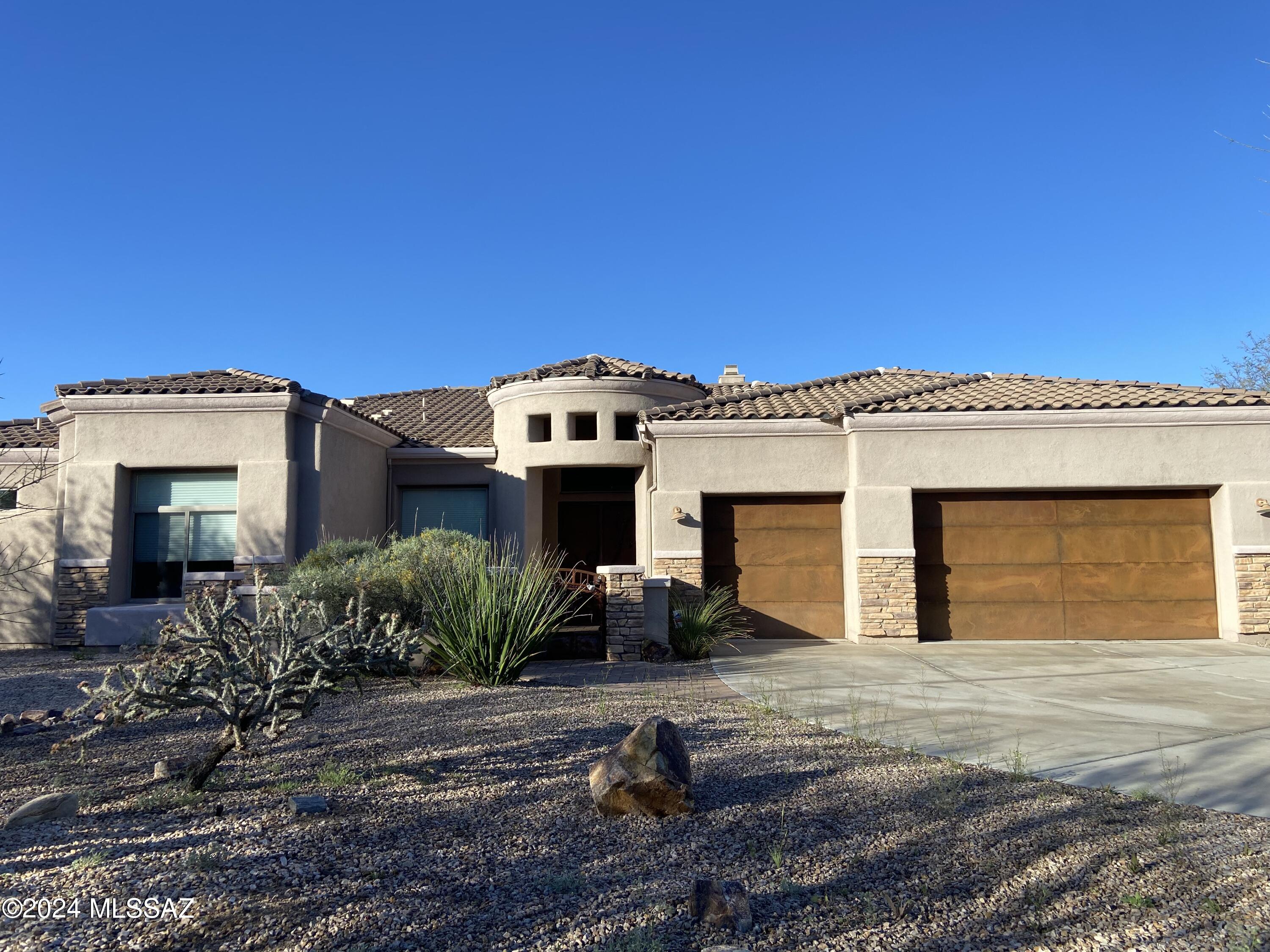 Discover luxury living in the gated Dos Lagos community within Dove Mountain nestled in a small enclave of semi-custom homes by A.F. Sterling. Upon arrival, the impressive entryway with double doors spills into the family room featuring soaring ceilings, stack stone fireplace and windows throughout, bringing in natural light for a warm and inviting space.  Gourmet kitchen with a breakfast bar blends seamlessly with the family and dining room, ideal for entertaining.  Split floor plan ensures privacy for family and guests, with a master suite that boasts a luxurious oversized bathroom. This residence also includes a 3-car garage and spacious lot with endless possibilities for your dream backyard oasis, complete with expansive covered patio and stunning views overlooking the adjacent golf course.  Don't miss your chance to make this private retreat yours.