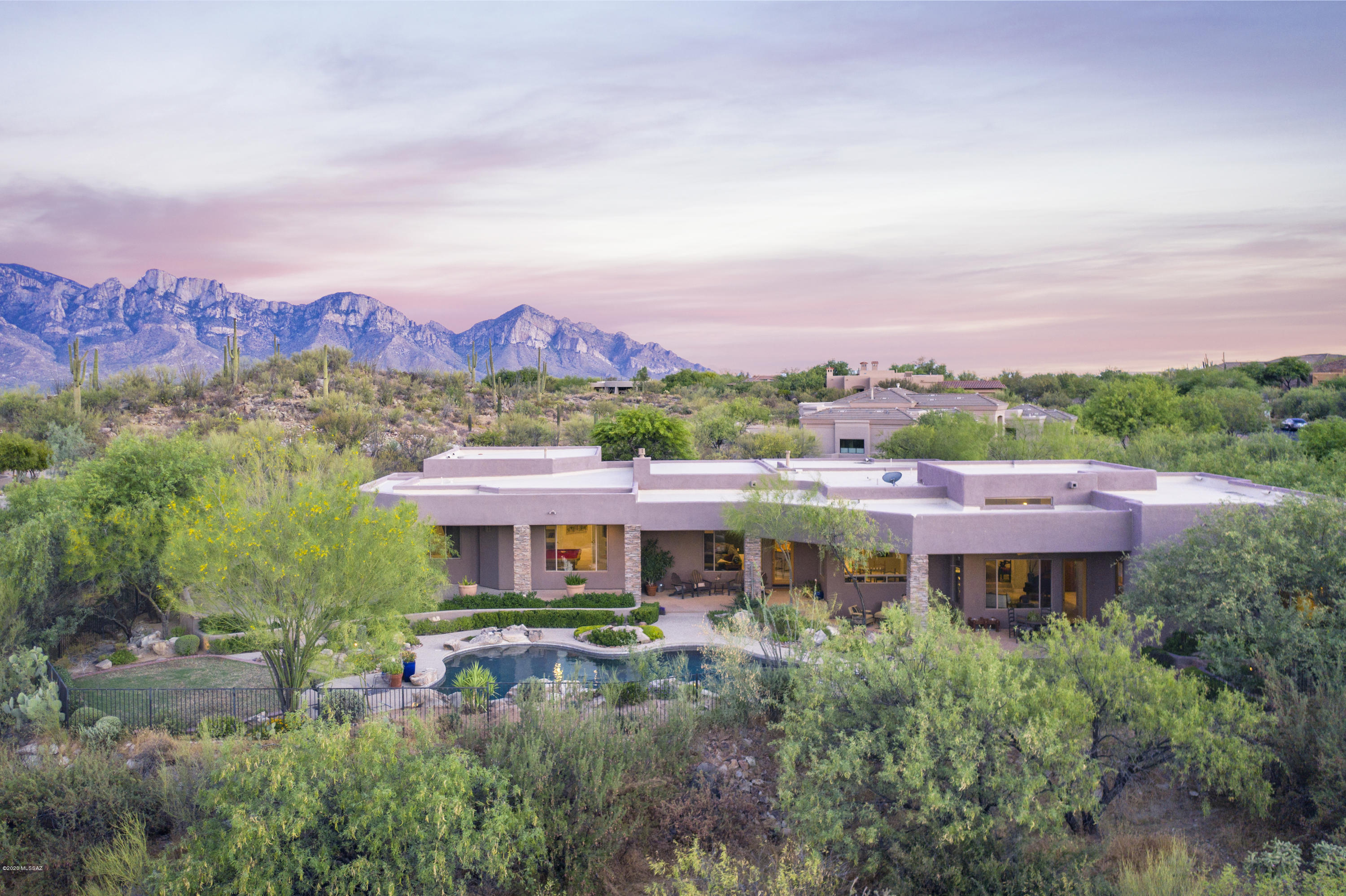 Gated Honey Bee Canyon Estates 5,163sf, 5BR 5Â½BA +game/media room w/sweeping Honey Bee Canyon & Pusch Ridge views. This home delivers w/travertine floors, new carpet, 4 fireplaces, formal living room, formal dining room, gourmet kitchen w/casual dining area, warming drawer, double convection ovens, gas & electric cooktops, Viking refrigerator & walk-in pantry. Wet bar & wine cooler. Family room w/entertainment wall. Surround sound in numerous rooms & patio. Master bedroom features fireplace his/her walk-in closets,travertine shower & spa tub. Rear yard has expansive patio views & privacy backing to Honey Bee Canyon w/Pebble tec pool, Kiva & outdoor kitchen. Oversized 4 car garage w/shop area & extended cab/boat bay. Central Vac, Intercom, alarm & 3-Zones HVAC