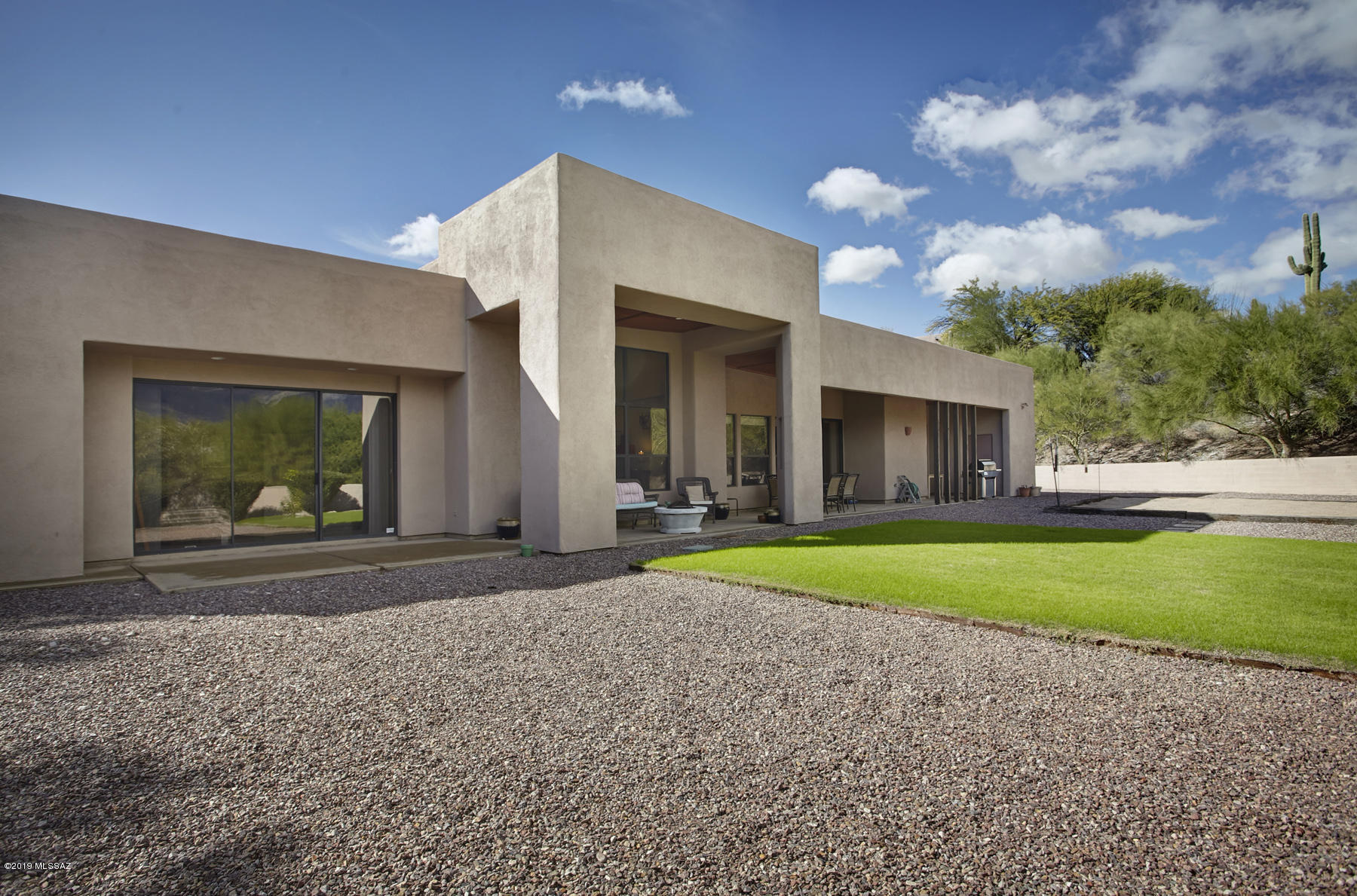 SOUTHWEST CONTEMPORARY DESIGN WITH GREAT FINISHES. MASTER SUITE OFFERS A SITTING AREA, GUEST BEDROOM WING HAS AN OPEN DEN. THE ATTACHED STUDIO/GUEST/OFFICE HAS A SEPARATE ENTRANCE (CURRENTLY USED AS ARCHITECT'S OFFICE). ALL ROOMS HAVE HIGH CEILINGS, WONDERFUL VIEWS AND PRIVACY.
LARGE WALLED YARD OFFERS MANY USES. 
NO HOA