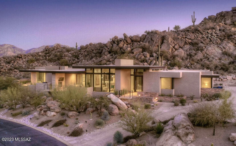 Looking for exquisite desert sophistication in your next residence? Start your search with this contemporary jewel in the incomparable beauty of Stone Canyon, as no other home you will tour will begin to compare to this property.  Framed by towering saguaros and nestled among a hillside that is accented with massive natural boulders, this home is desert living at its finest.
The graceful lines of the Sonoran Desert are in perfect concert with the masterful design of architect Kevin Howard, making it easy to see why the Wall Street Journal just featured his divine desert work in Feb.'23. Expansive walls of glass throughout allow for these magnificent desert features to be on prominent display while drawing natural light to illuminate the interior. As you open the grand pivot door you are greeted by a massive saguaro creating a seamless indoor/ outdoor transition. The sleek kitchen is equipped with Miele appliances, individual refrigerator/freezer, double oven and  Poliform custom cabinetry imported from Italy. 
This fully furnished home offers 3 large ensuite bedrooms, Control 4 Automation, 3 car garage, along with automatic shades throughout the residence. 
The impeccable beauty within this home is met with uninterrupted flow to the refined beauty outside. With multiple outdoor living areas, fireplace for cooler evenings, an outdoor tv, BBQ grill and spool overlooking the breathtaking Tortolita Mtns. 
Further, Oro Valley has repeatedly been ranked as one of the safest cities in AZ. Featuring incredible restaurants, hiking & biking trails, top rated schools and so much more.  Not to mention, the unparalleled luxury of Stone Canyon.  Within the gates, you can enjoy the Clubhouse, Health & Fitness Center and Golf Club consistently ranked in the top 100 residential golf courses in the nation.