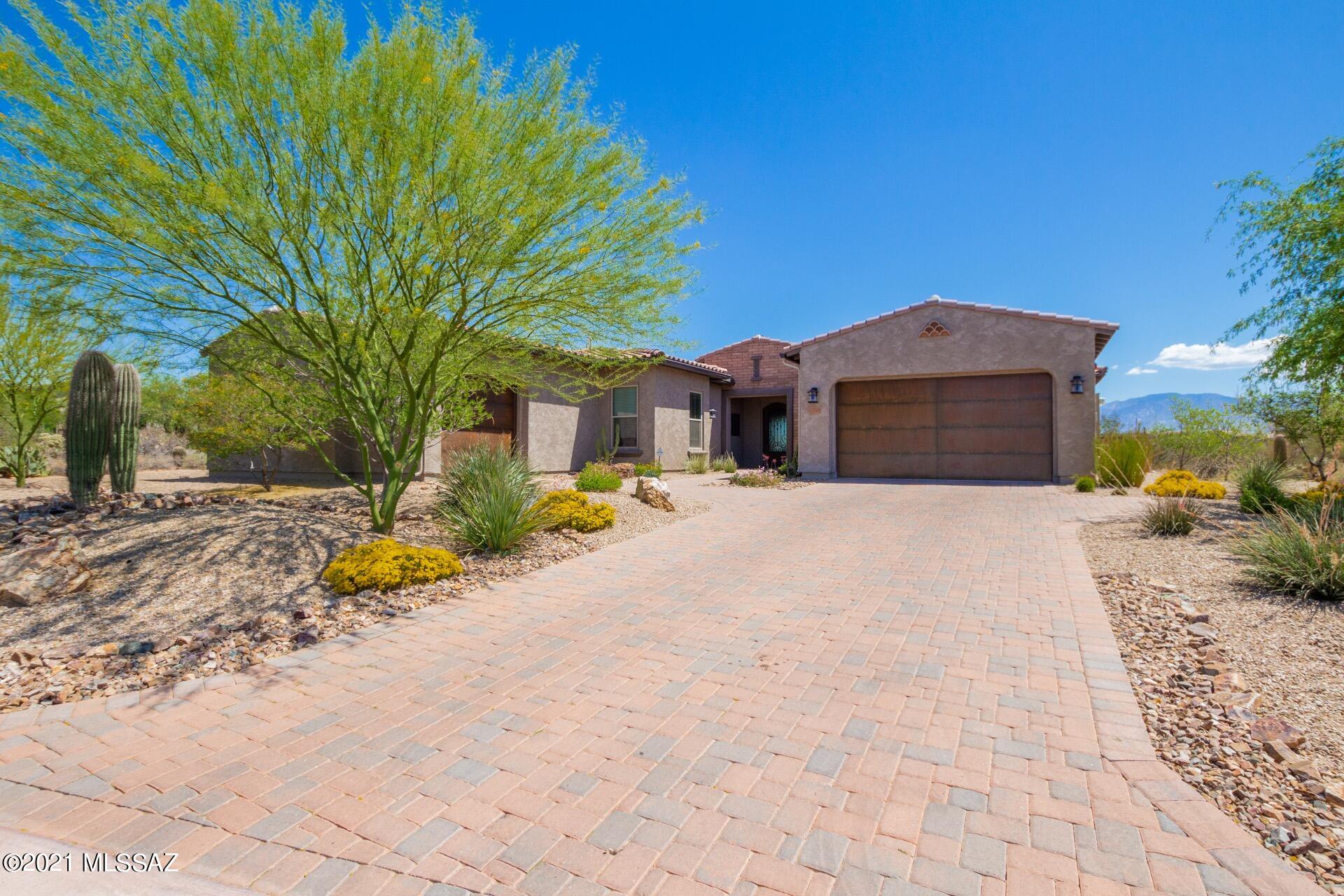 Step into this meticulously maintained home with breathtaking Mountain views and many upgrades. Enjoy the spacious open floor plan, handsome wood look tile floors, with a den & formal dining room. Stunning chef's kitchen features a center island with quartz counters, breakfast bar, pendant lighting, SS appliances including a Dacor refrigerator. Large panty & gorgeous wood cabinetry with crown molding fill out the kitchen.  Breakfast area has natural light and patio access. Additional carpeted living area which can be used as a great office or den. Grand master bedroom boasts a sitting area, bathroom with dual sinks and a walk-in closet with a built in California Closets arraignment. 3-Car garage is insulated with epoxy floors & cabinets. Sensational backyard with a covered travertine pati Breakfast area has natural light and patio access.  Large laundry room with storage cabinets & sink!