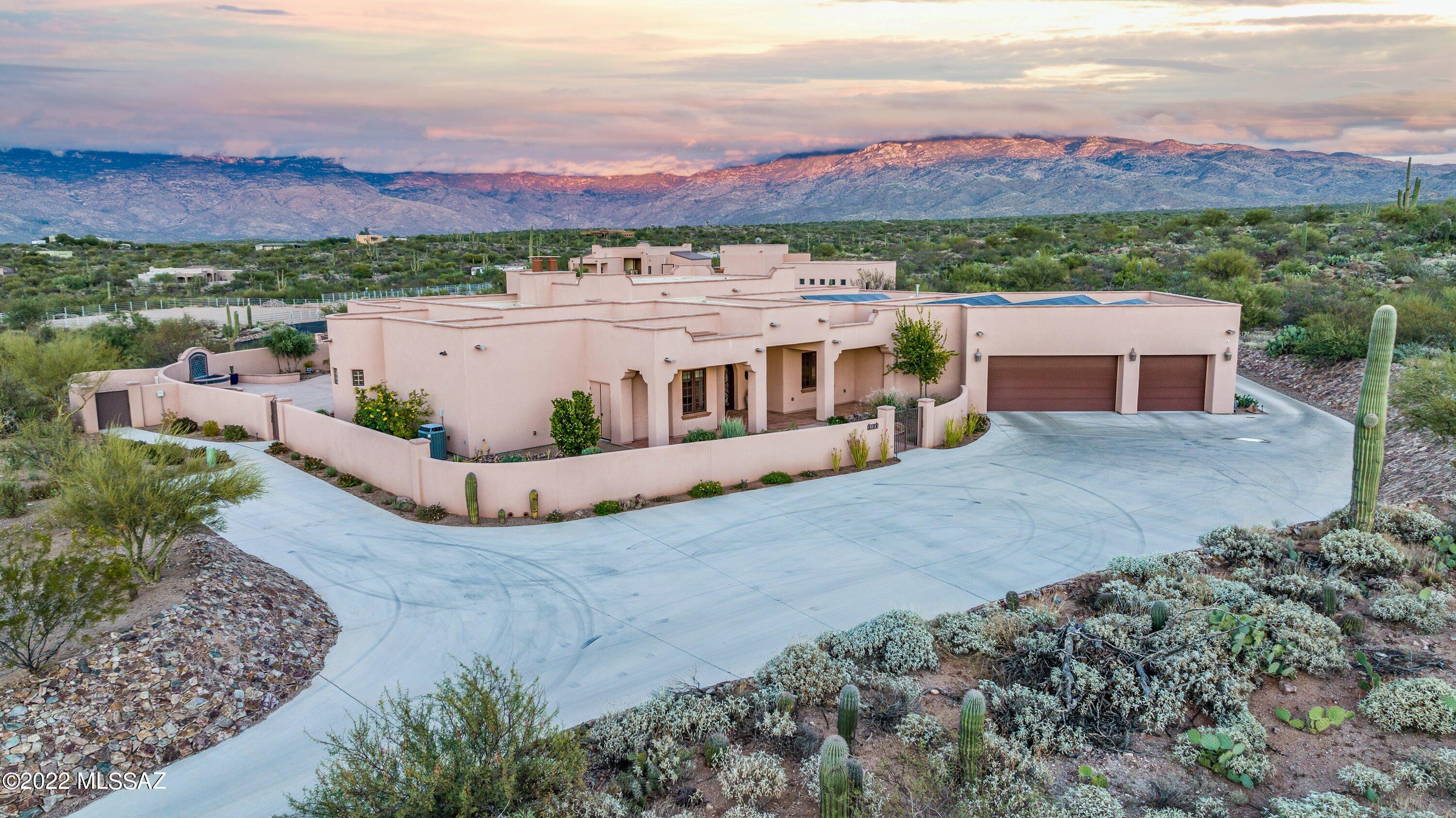 Beautiful Sonoran Desert compound! On 10 acres of previously native Sonoran Desert in the foothills of the Rincon Mountains lies a superbly developed home and equestrian facility.  The house is 3688 square feet in the Spanish Colonial Revival style complete with classic interior detailing.  Doorway arches, wall and floor niches, inlay mosaic tile flooring, beamed and corbeled ceilings, and fabulous built-ins are among the many findings that distinguish this home.  Modern amenities abound with an eye to extreme energy efficiency including sprayed foam insulation throughout (including the garage), high-end clad windows, insulated overhead doors, ultimate efficiency air conditioner units, rooftop solar energy panels and LED lighting throughout. The adherence to Spanish Colonial style will impress. The entry doors are arched fabricated steel, all installed light fixtures are custom wrought iron and alabaster, the main hallway has plastered crown detailing, floors are Versailles-pattern imported porcelain tiles throughout and skylights bring natural light to the central interior. Modern conveniences abound including ultra-efficient appliances, maximum sized kitchen sink, hot water dispenser, home-wide streaming sound system, and installed video equipment.  Work-at-home owners will find the study perfect for two with built in desks and wi-fi access throughout. High speed cable service comes right to the center of the property allowing for up to gigabyte speeds. Huge porches under the roof shade virtually all windows for limited heat gain during even the hottest spells. The interior courtyards are completely walled including a tiled fountain, large rectangular swimming pool with natural gas heating, professional landscaping with drip irrigation and fabulous hand-placed rock work.  Other buildings on the compound include two insulated workshops both with heat pump HVAC and a custom stables and arena.  Your horses will remain comfortable with the insulated barn with fan and cooler ventilation. The unique details are endless. Come see for yourself!