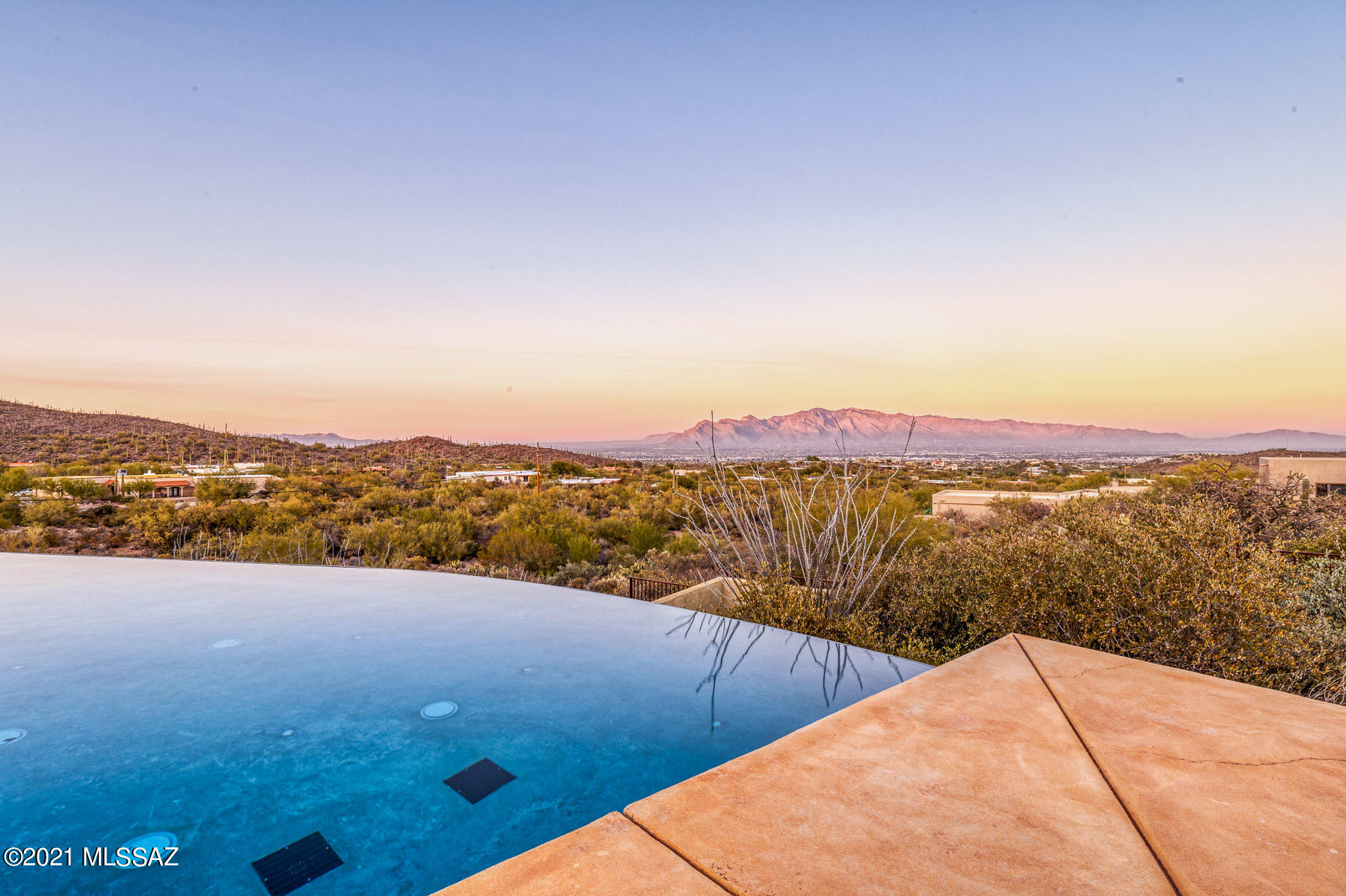 This custom extremely private gated Estate with breathtaking mountain views awaits you. Located in the Tucson Mountains and borders The Saguaro National Monument. This home offers secluded quiet country living minutes from all the best that Tucson has to offer. Only minutes from downtown, fine dining and with hiking, biking, and a wonderland of outdoor activities close by, you will find yourself in paradise. This property was meticulously designed to accommodate daily family activities and comfortable social gatherings. This home has it all, presidential master suite, den/office, living room, gourmet kitchen, infinity pool, and guest house. The gourmet kitchen with 3 islands and family room hosts a gas cooktop with oversized custom exhaust, stainless steel appliances and fireplace to enjoy the fabulous views. In your resort style backyard with infinity pool, spa, covered patios and built-in barbecue you will find yourself entertaining guests and taking extra time to enjoy those quiet starry nights and our legendary Arizona sunsets with loved ones. In your oversized garage you will have excess room and a refined look with ample built in storage. You don't want to miss this one!