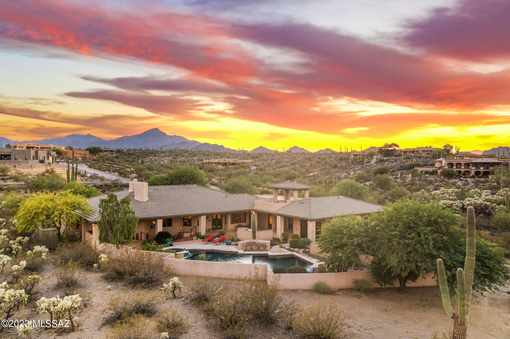 Exquisite Soft Contemporary Sanctuary: Breathtaking Catalina Vistas Await!
Step into a world of unparalleled luxury nestled on 3.3 acres with Majestic Saguaros as the backdrop. This custom-designed, 4,630 sqft Mark Soloway Southwestern design epitomizes the very essence of elegant living, combining soft contemporary lines with timeless sophistication. Delight in the sweeping, ever-changing vistas of the majestic Catalina mountains, perfectly framed by the expansive Pella windows in the grand family room. The towering 15-foot ceilings create an airy ambiance, captivating natural light beautifully illuminates this home, enhancing the traditional travertine floors that sweep seamlessly throughout the residence. At the heart of this magnificent home is a chef's dream kitchen, adorned with natural cherry wood cabinets that exude warmth and character. The granite counters contrast beautifully, complemented by GE Profile stainless steel appliances. From the gas cooktop crowned by a custom hood to the double ovens. Entertain or enjoy intimate family meals on the large granite island.

Every one of the five generously sized bedrooms boasts its own ensuite bath, offering unrivaled privacy and comfort. For guests or extended family, the property also features a splendid guest house. Equipped with a kitchenette, featuring granite countertops and stainless steel appliances, a cozy living room, a bedroom, and a bath, it promises complete privacy. Double French doors open to a private patio, allowing guests to relish the serene surroundings.

Stepping outdoors, the resort-inspired amenities will captivate you. Dive into the shimmering pool, unwind in the spa. Evoking the ambiance of a five-star resort, the spacious observation deck is a perfect venue for gathering with friends and family, celebrating special moments, or simply gazing at the night sky and city lights.

Additional exquisite features include Brazilian cherry and travertine floors, crown molding, a spacious walk-in pantry, a central vacuum system, surround sound, and a commodious 4-car garage.

Bask in the joy of a vibrant lifestyle amidst the majestic Sonoran desert, moments away from a bustling downtown brimming with gourmet food, exquisite wines, art, and festivities. In a community that deeply values nature's allure, refined living, and a rich cultural tapestry, this home isn't simply a place to resideit's a jubilant place to live and it's a crafted work of art in itself.

Don't miss out on the opportunity to make this exclusive sanctuary yours. Contact us today and experience the epitome of luxurious living firsthand.