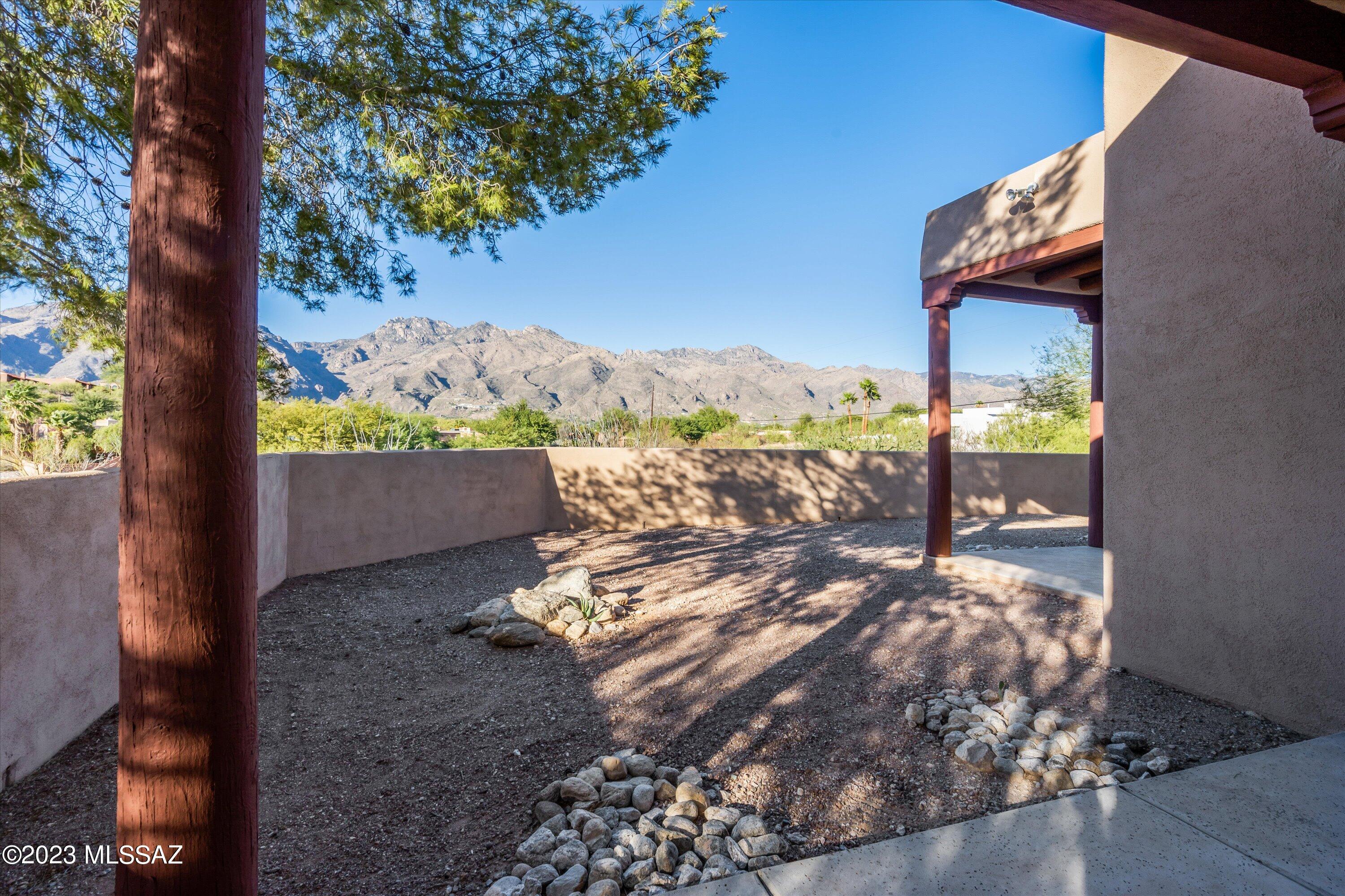 Amazing 3/2.5 Santa Fe minutes from Ventana CC with premium views and an elevated corner lot make this home simply one of a kind. Inside this home is a true SW gem with Mexican tile floors, high ceilings, tongue and groove ceilings with natural wood beams at foyer make this home aesthetically on point for those with an architectural love of the Southwest. Tiled baths, kitchen counters, and kiva fireplaces add to the SW sophistication this home offers. Outside this home shines with multiple backyards perfect for dogs or gardeners. Large patios complemented in natural rough saw post and beams enhance the Tucson lifestyle all winter long. This home shows better in person than online and its priced to sell so schedule you showing today!