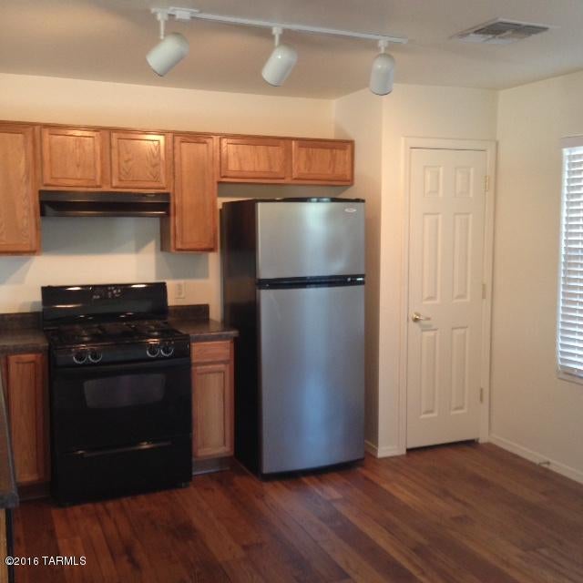 Spacious three bedroom 2 bath, one car garage home located in desirable location. Bright and open this home has living areas downstairs and bedrooms upstairs. New flooring in kitchen, baths and laundry room. Extra large backyard. Close to shopping, restaurants, UofA and more! A MUST SEE.