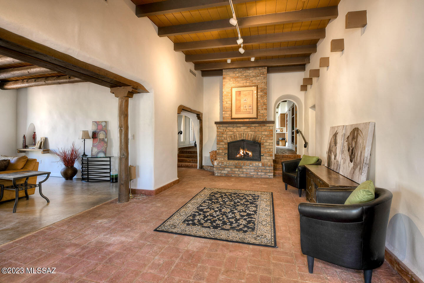 Unique Mid Century Ranch Home on 3.34 Acre Gated Horse Property in the Tanque Verde Valley. Exposed Beams, Arched Doorways, Hand Plastered Interior Walls & Brick Flooring are Joessler Inspired Touches that Add Character to the Space. Numerous Windows Allow Natural Light to Brighten the Interior. The Split-Level Floor Plan is Divided by Magnificent Back-to-Back Fireplaces. Primary Suite also has a Kiva Fireplace in the Sunken Sitting Area plus an Enclosed Arizona Room. Kitchen Features Talavera Tile Backsplash, Mid Century St. Charles Metal Cabinets, Décor Gas Range, Bosch Dishwasher & Brand-New Subzero Refrigerator. Numerous Courtyards & Patios Surround the Home and Provide Access to Beautiful Landscaping, a Tranquil Fountain, Backyard Pond & Sparkling Pool with Gorgeous Mountain Views!