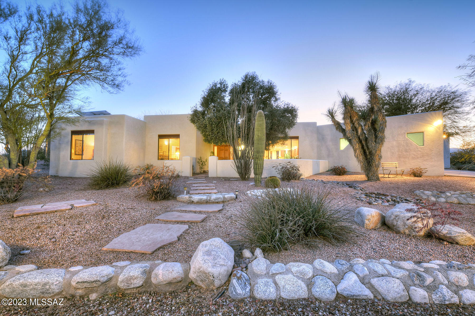 Beautiful Westside 4 bedroom 2 bathroom home and 1031 sq ft two bedroom guest home with stunning Catalina Mountain, City & Tucson Mt views!  This very enchanting home features: 11 ft beam & plank ceilings, lighted decorative niches, double sided fireplace, large windows, colored concrete floors & French doors to patio. 4 bedrooms in the main home.  Master is ample w/en-suite bathroom with soaking tub & separate shower, double sinks & walk-in closet. Living room & Family room off updated kitchen, with newer appliances, gorgeous Quartzite counter tops with gobs of counter space,  Mexican tiled back splash, re-stained cabinetry, breakfast bar and breakfast niche with built-in bench seating and custom Southwest table. Custom window treatments convey. Backyard has covered patio, water feature & 60' Pebble Tec lap pool recently resurfaced .  Large 2 bedroom 1 bathroom 1016 sq ft guest house has colored concrete floors, wood plank & beamed ceiling, full kitchen, corner gas fireplace great room floor plan plus a covered patio with a fireplace! Solar! 2 car garage all on an incredible 1 acre lot with abundant wildlife & diverse Southwest Desert flora! NO HOA!